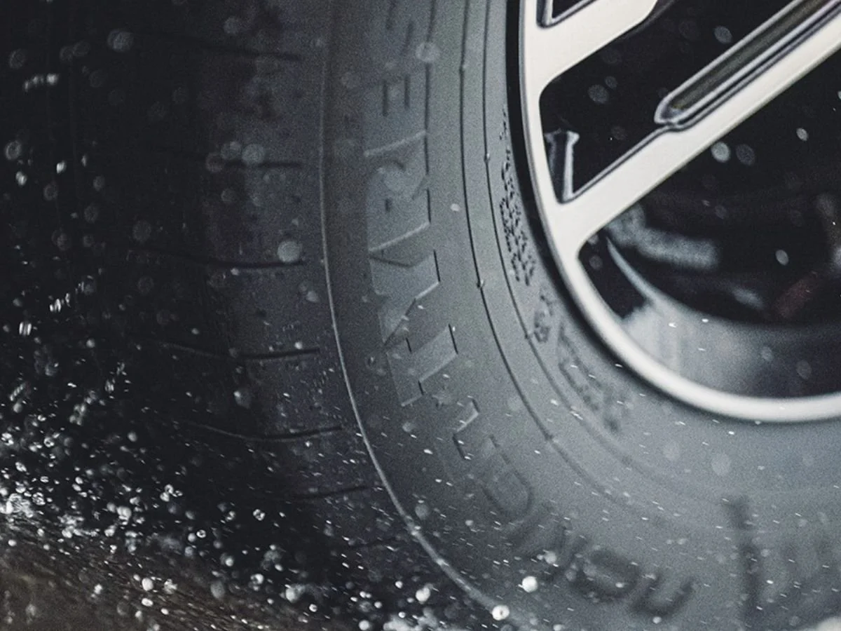 Nokian Tyres One all-season tire with Aramid Sidewall technology splashing through a large water puddle.