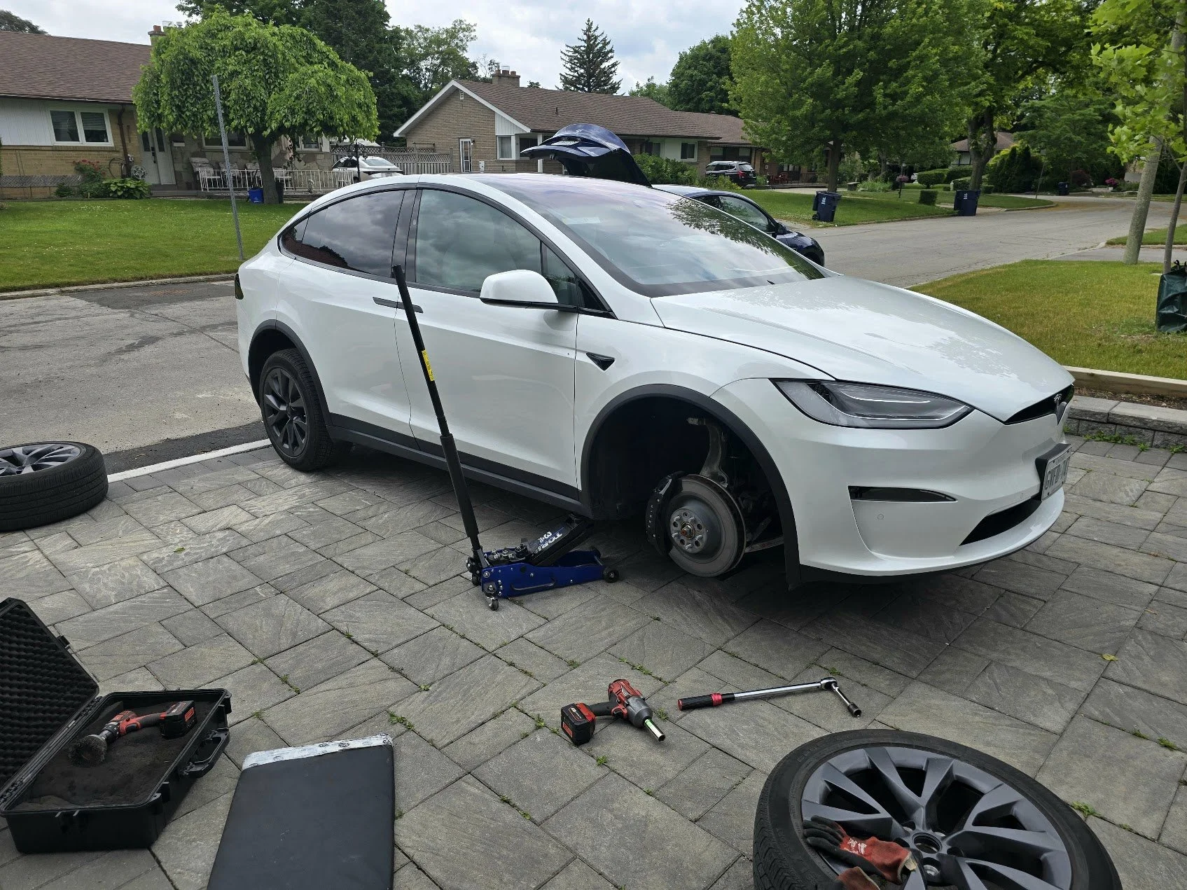 Changing tires on a Tesla Model X in North York, in customer's driveway.