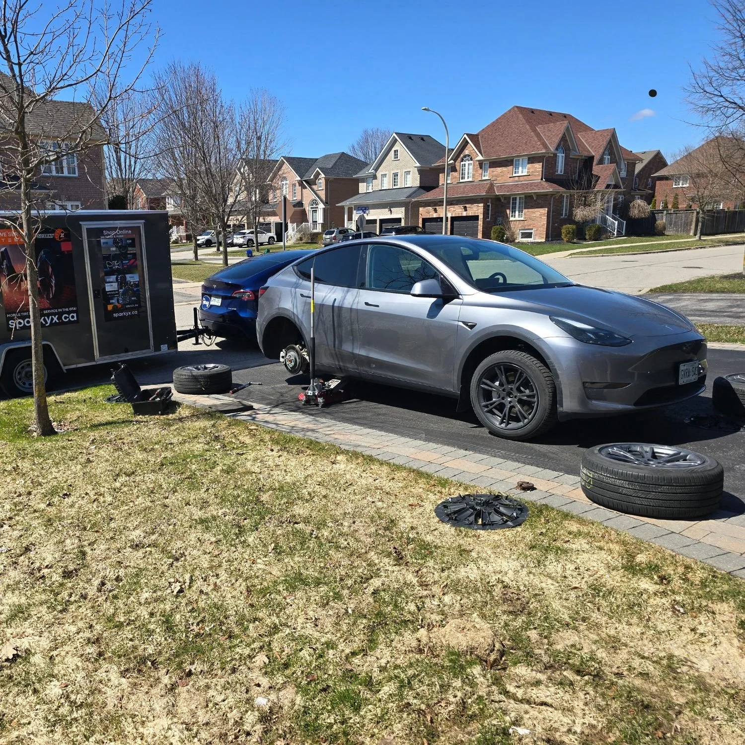 Swapping winter to summer wheels in Whitby, Ontario, for a customer with a Tesla Model Y, in his driveway.
