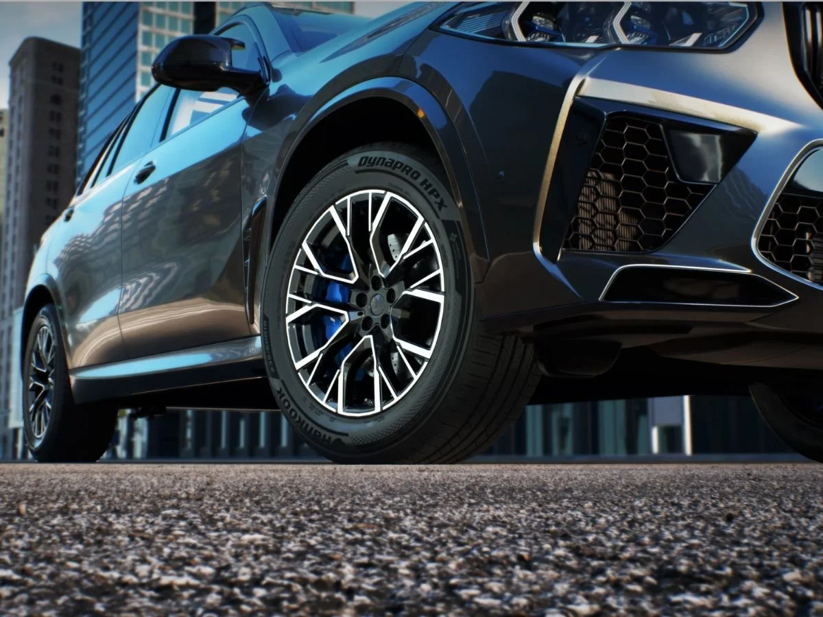 Hankook Dynapro HPX all-season tire with high-gloss multi-spoke wheel on a gray performance SUV.