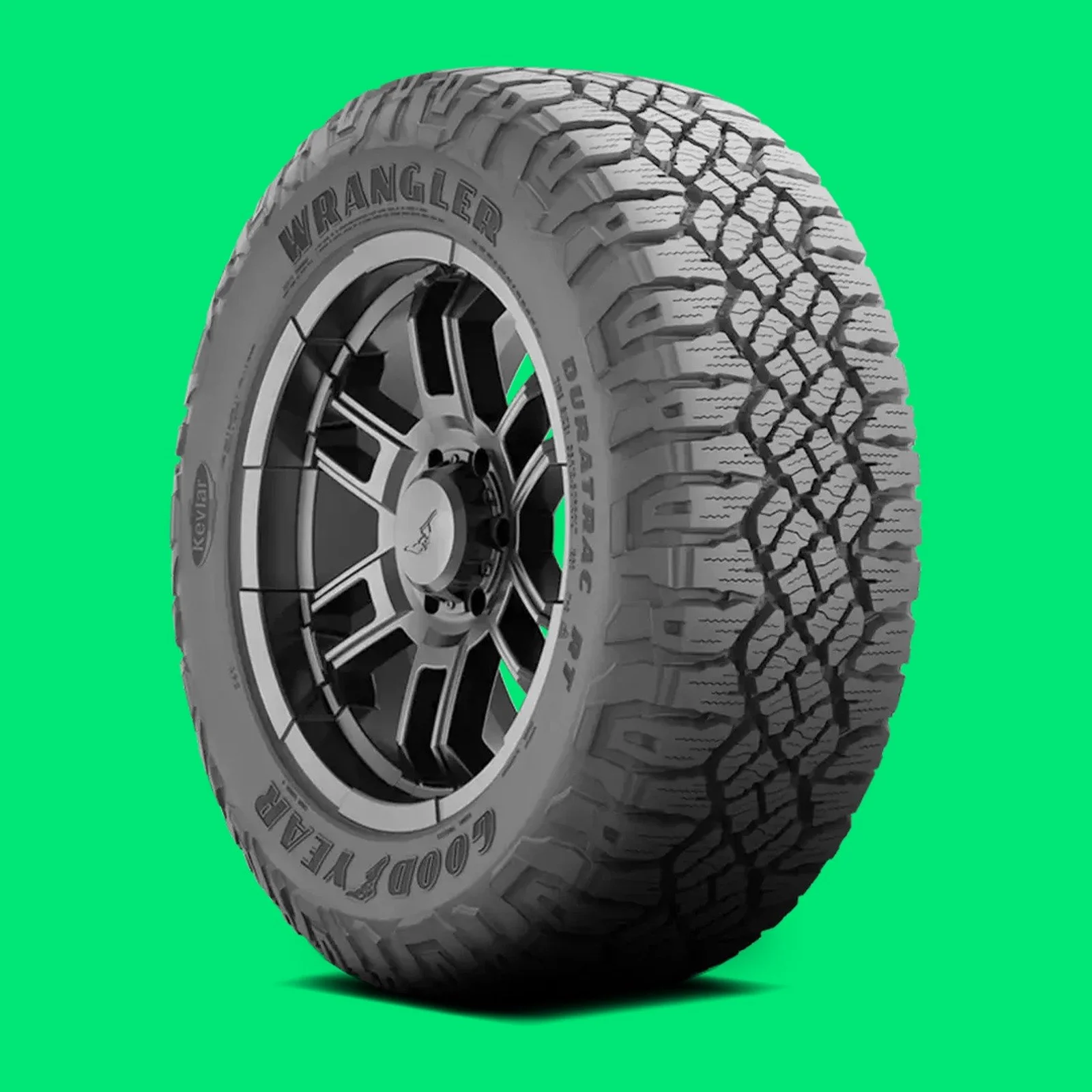Goodyear Wrangler DuraTrac RT rugged-terrain tire on a vivid emerald background