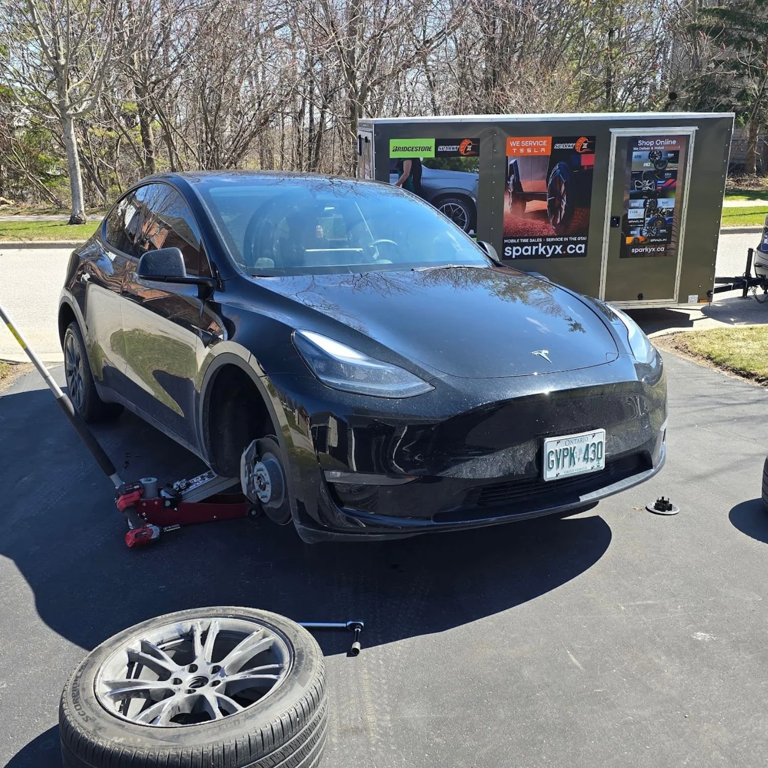 Seasonal tire change in Bowmanville, Ontario, for a customer with a Tesla Model Y, at home, in their driveway.