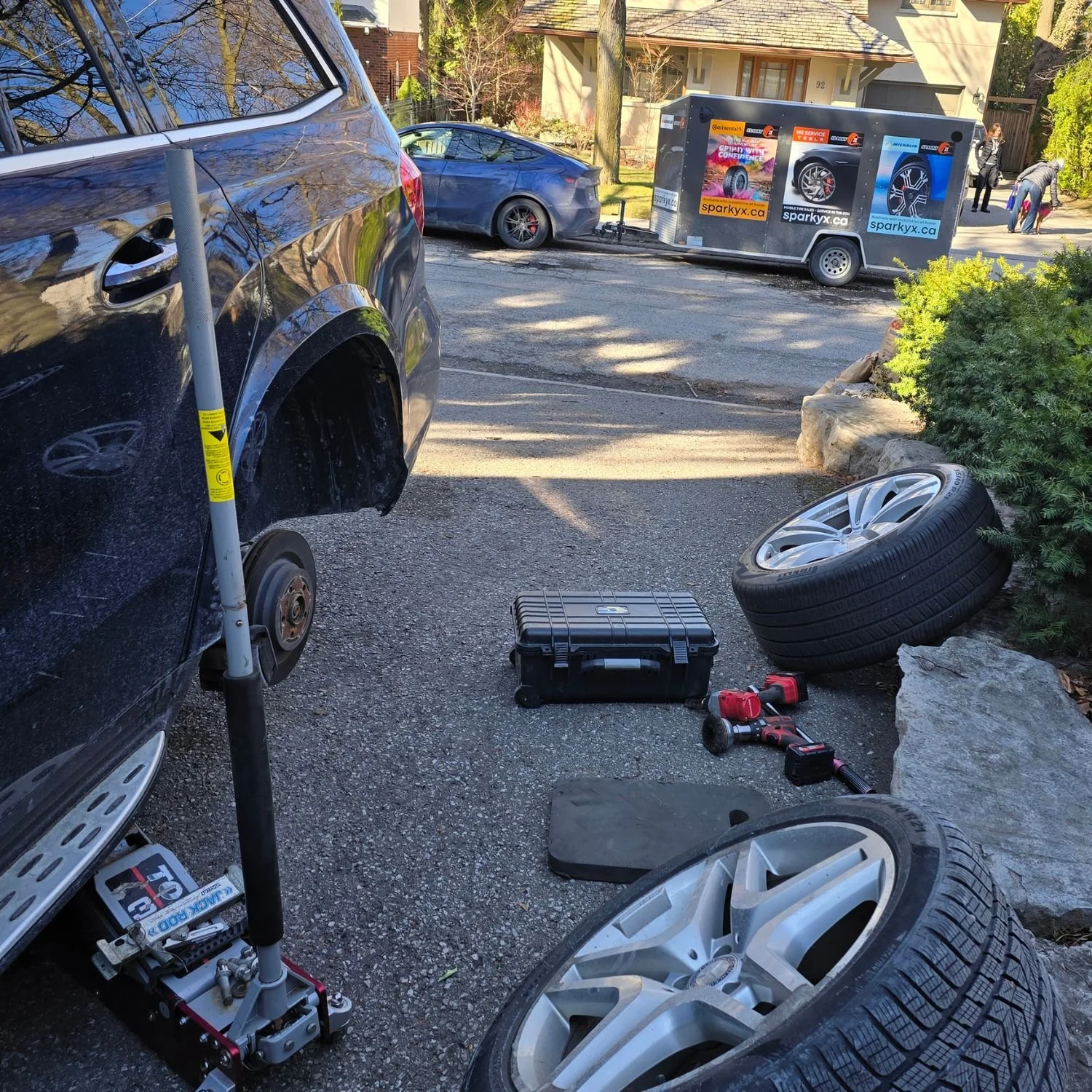 Mobile tire rotation for a large Mercedes Benz SUV, provided in the driveway for a customer in the Lawrence Park area, in Toronto, Ontario.
