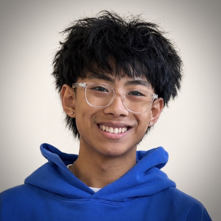 Smiling team member with glasses, short hair, and earrings on Cherubs white backdrop.