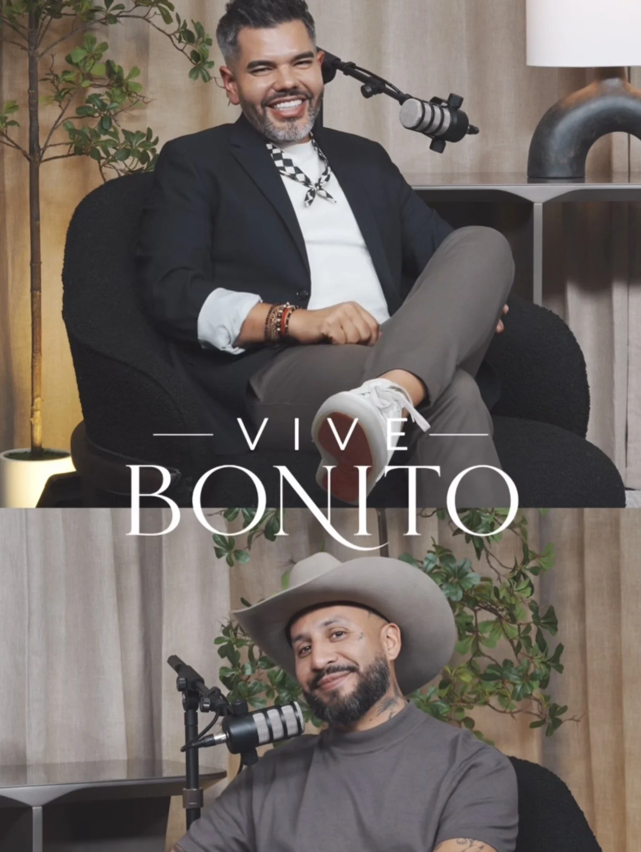 Two men sitting in front of microphones, smiling for a photo. The top man has gray hair, a beard, and is dressed in a black blazer with a patterned scarf. The bottom man has a beard and mustache, wearing a large cowboy hat and a gray shirt, with patt
