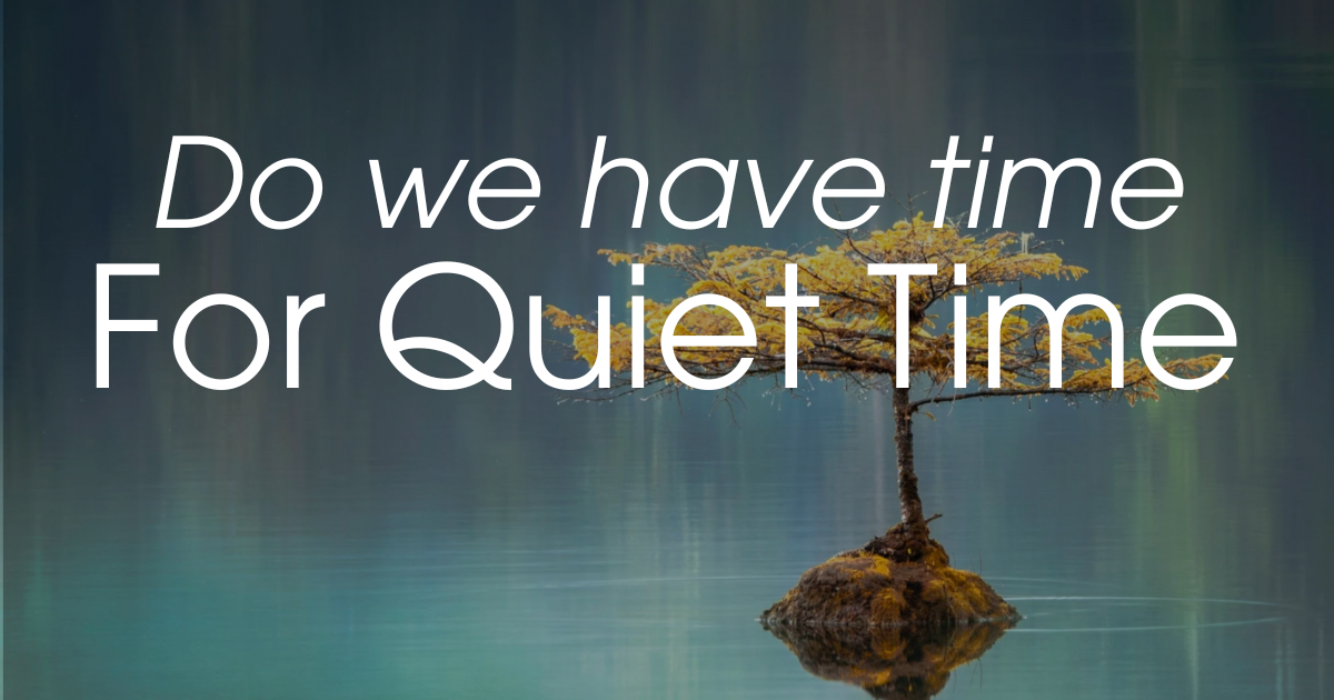 A solitary tree growing on a small mound in calm water, with a reflection of the tree and a blurred background.