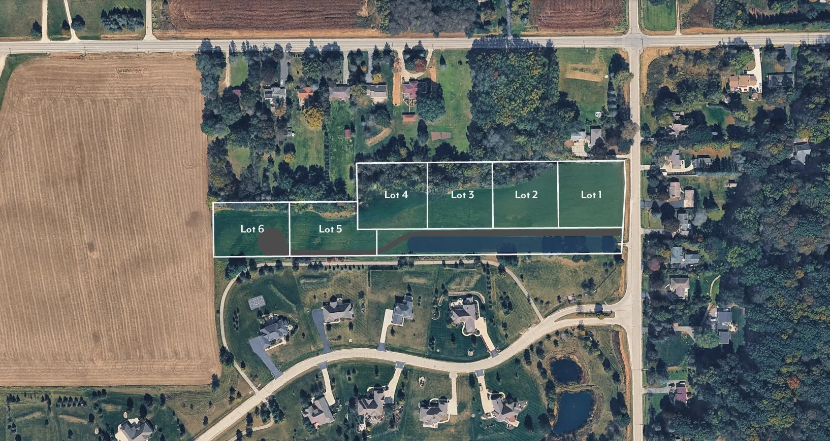 Aerial view of a residential area with outlined lots labeled 1 through 6, showing neighboring houses, roads, and open fields.