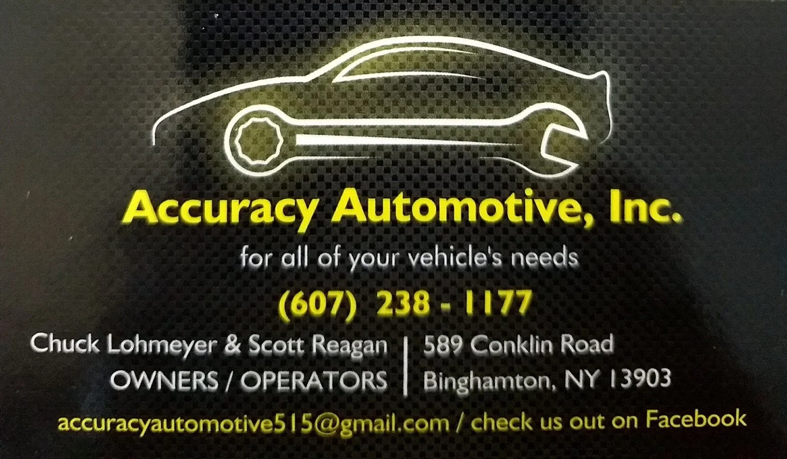 A neon sign with a wrench and car outline, displaying the business name 'Accuracy Automotive, Inc.' and contact information.