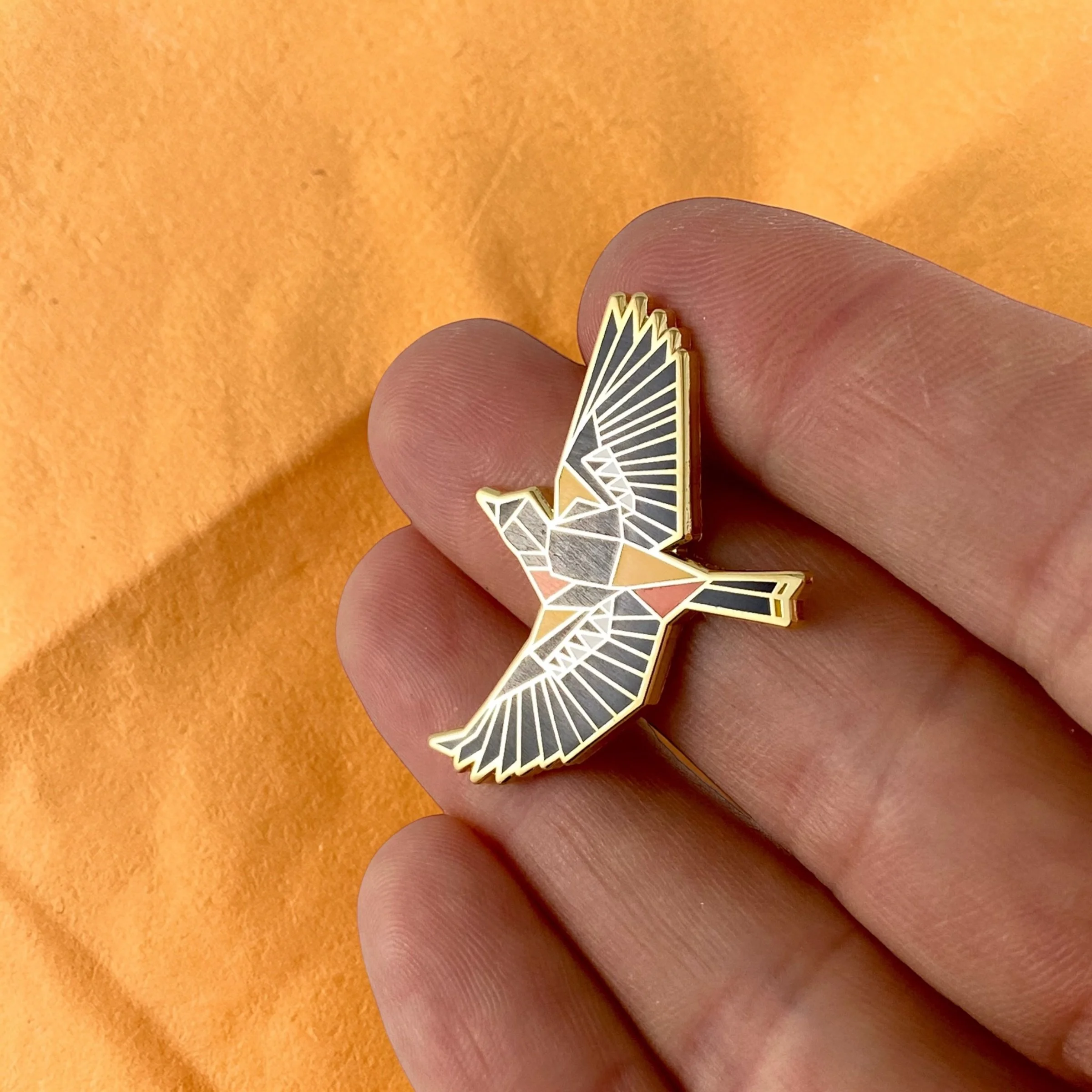 Baltimore Oriole enamel pin – a unique bird themed gift for bird lovers and backyard bird watchers. Hard enamel pin with secure double pin backing and original FoldIT Creations design.