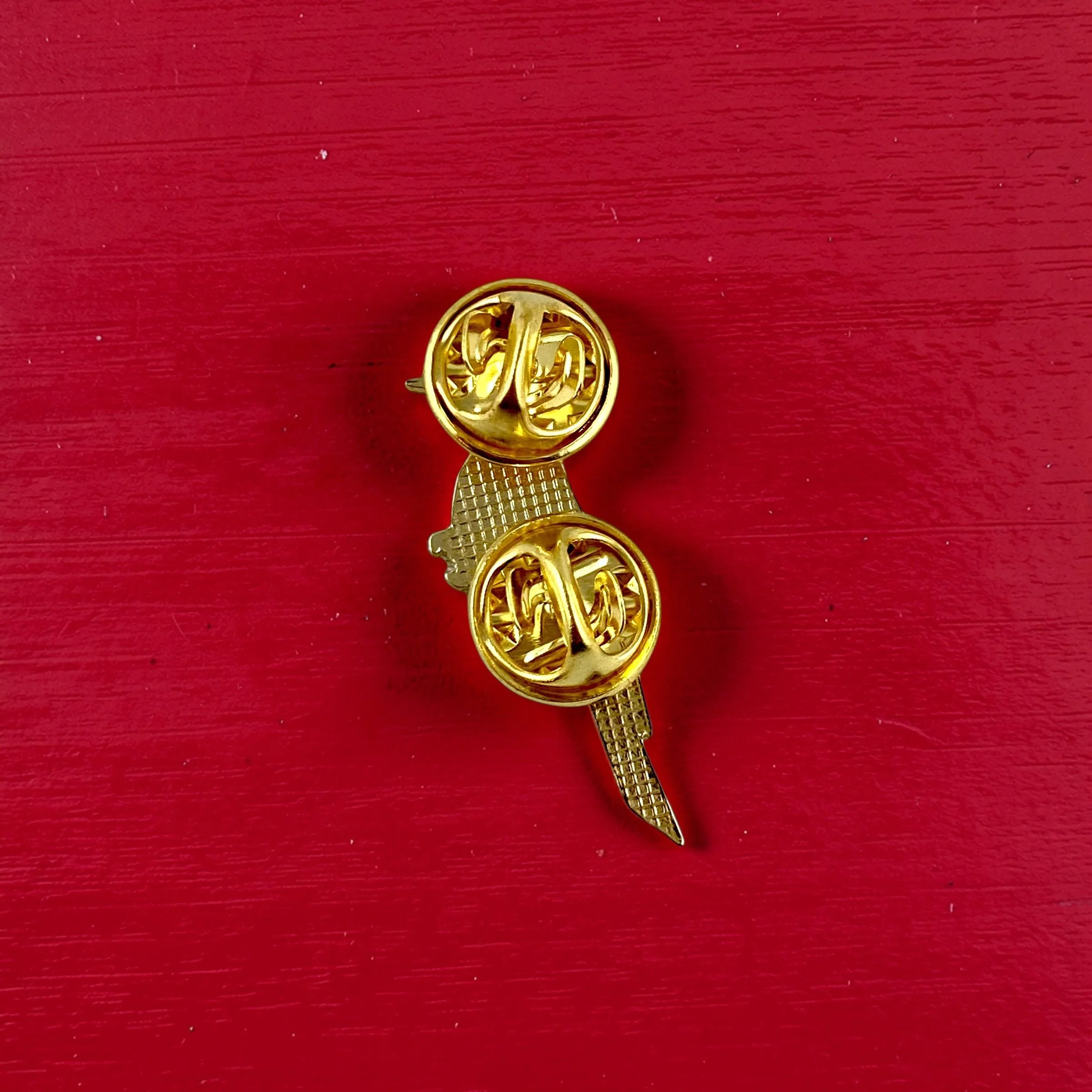 Origami pileated woodpecker enamel pin – a unique bird themed gift for bird lovers and bird watchers. Soft enamel pin with secure double pin backing and original FoldIT Creations design.