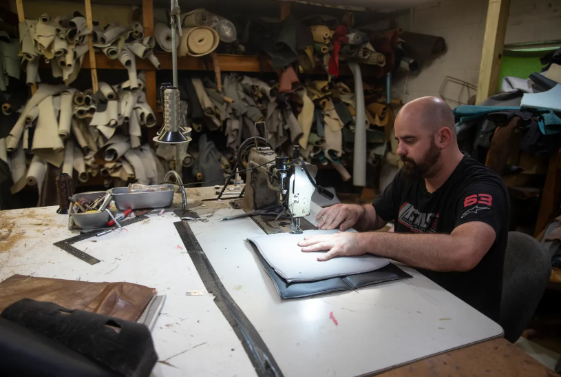 man at sewing manchine