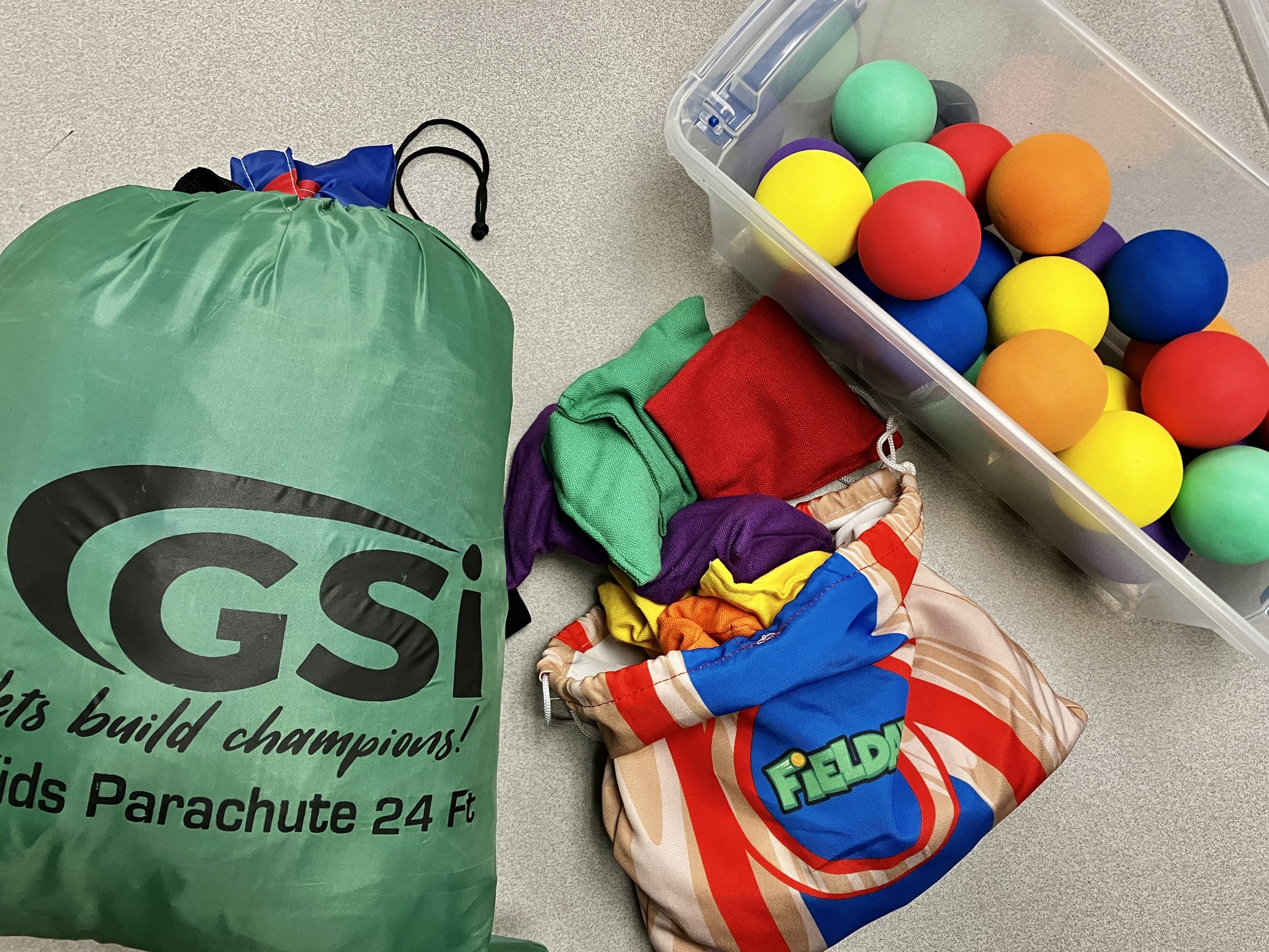 Image of parachute in a bag, with bean bags and foam balls