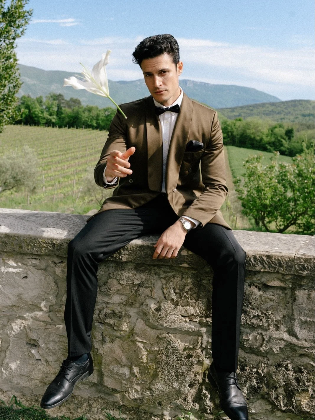 The groom: Earthbound elegance.

Grooms look comes to life through this olive-brown double-breasted jacket, expertly bridging the gap between old-world castle architecture and the organic textures of the vineyard. It&rsquo;s a masterclass in tonal dr