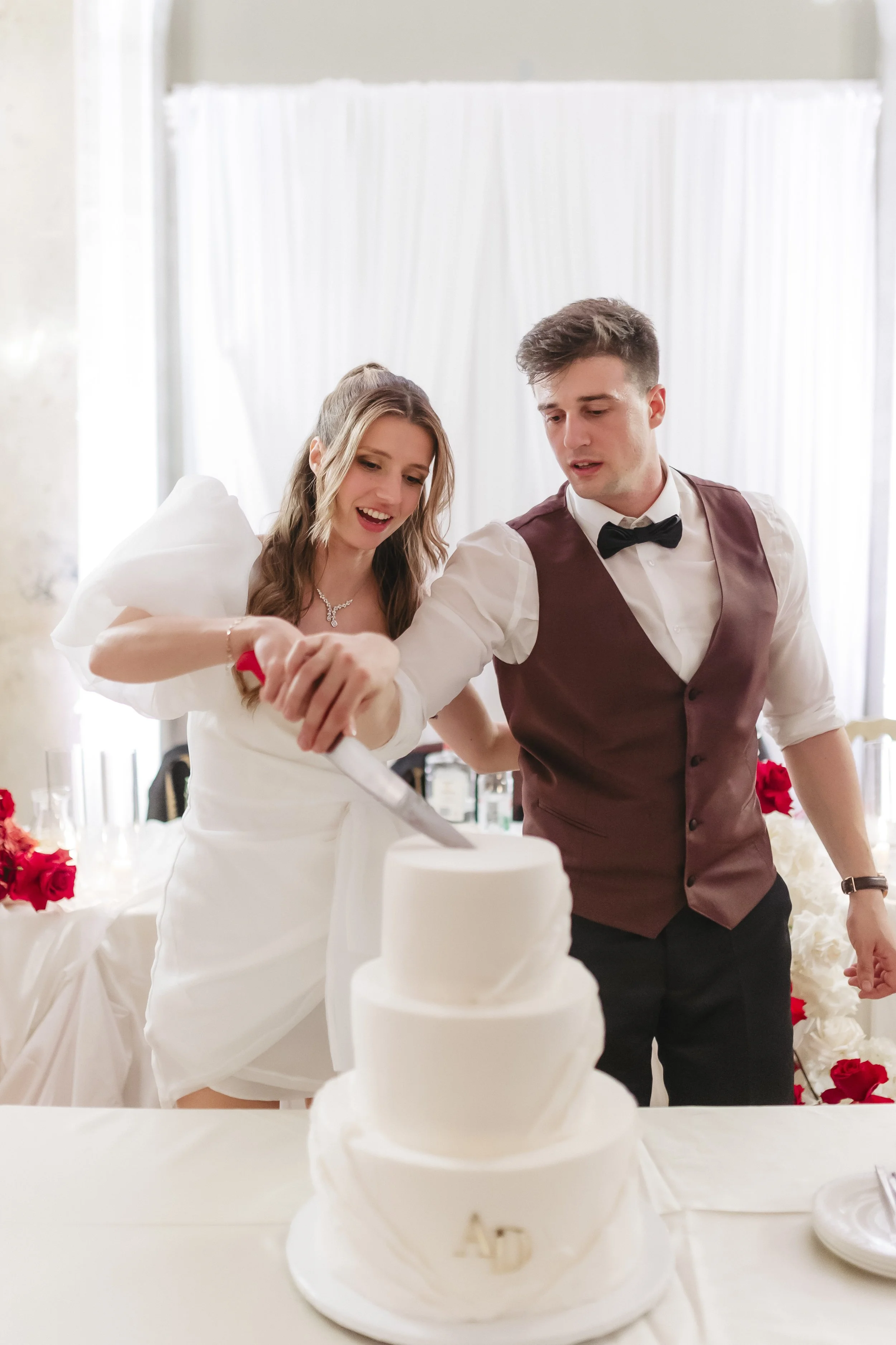 white-wedding-cake-cutting-newlyweds.jpg