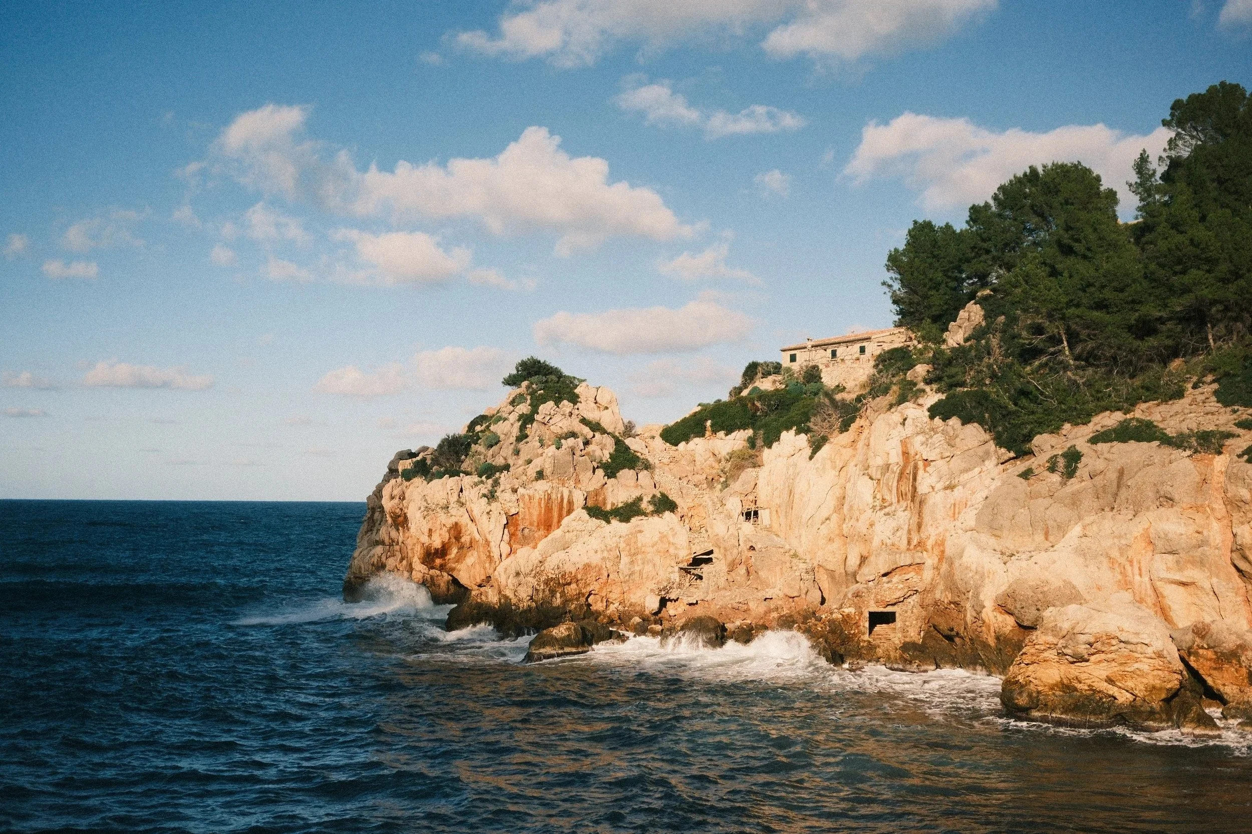 Pine-topped rocky headland above a deep blue sea, Mallorca, Spain - fine art print by Zyan Sachs