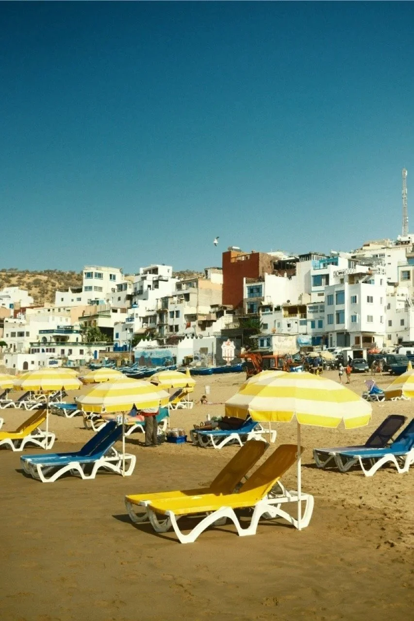 Yellow sun loungers on the beach below the town, Taghazout, Morocco - fine art print by Zyan Sachs