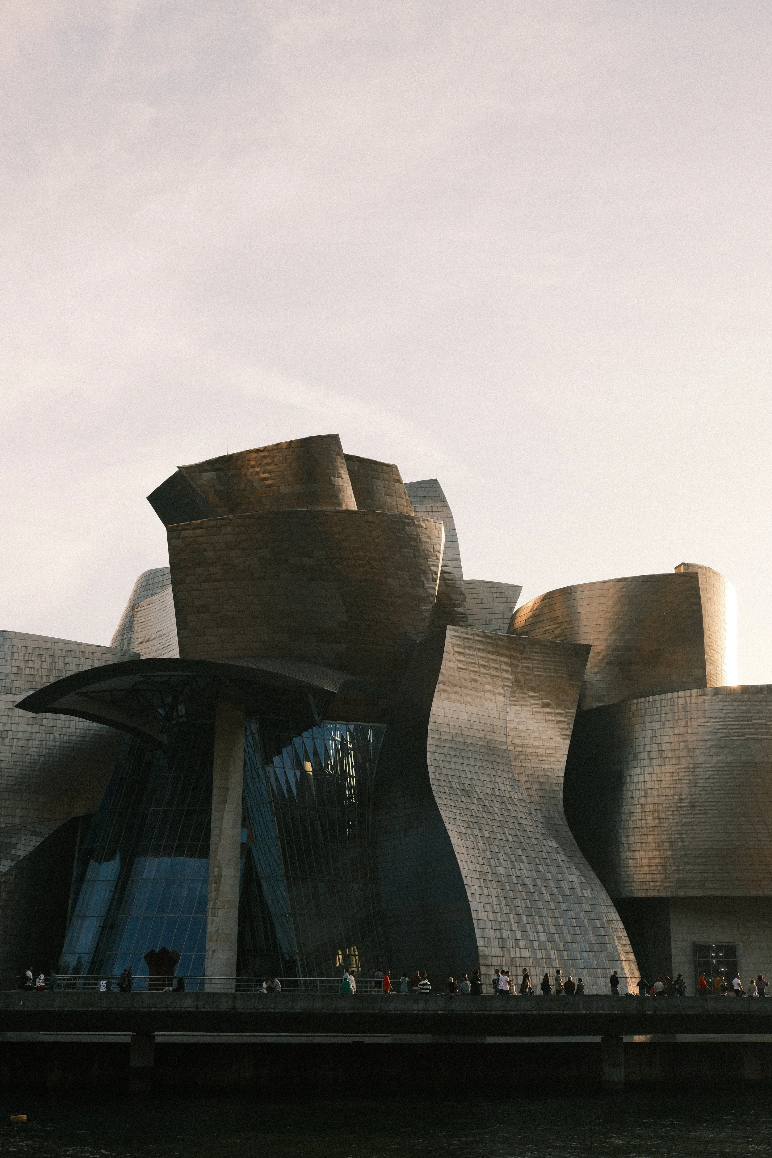 Guggenheim Museum's titanium curves under an overcast sky, Bilbao, Basque Country, Spain, by Zyan Sachs