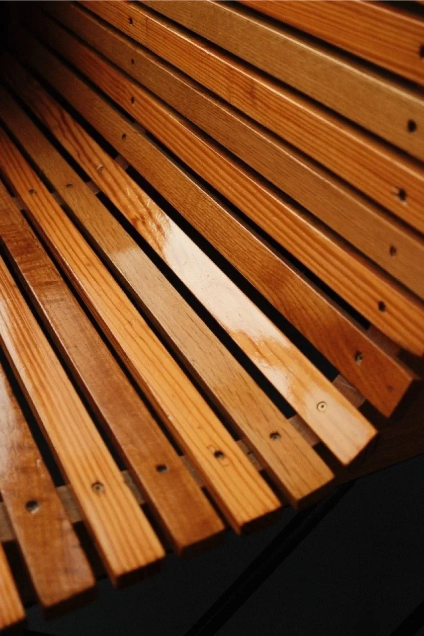 Curving wooden slats of a sun lounger in warm light, Mallorca, Spain - fine art print by Zyan Sachs