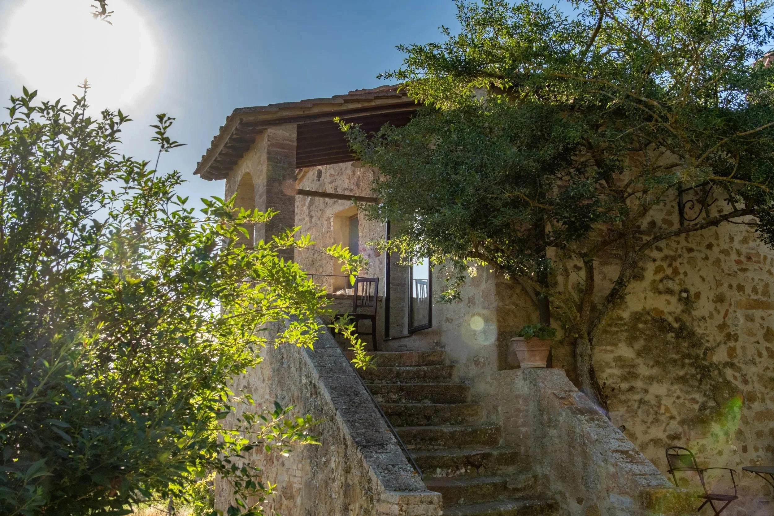 Stone stairs up to the farmhouse in morning light at Agriturismo Selvoli, Val d'Orcia, Tuscany - hospitality photography by Zyan Sachs