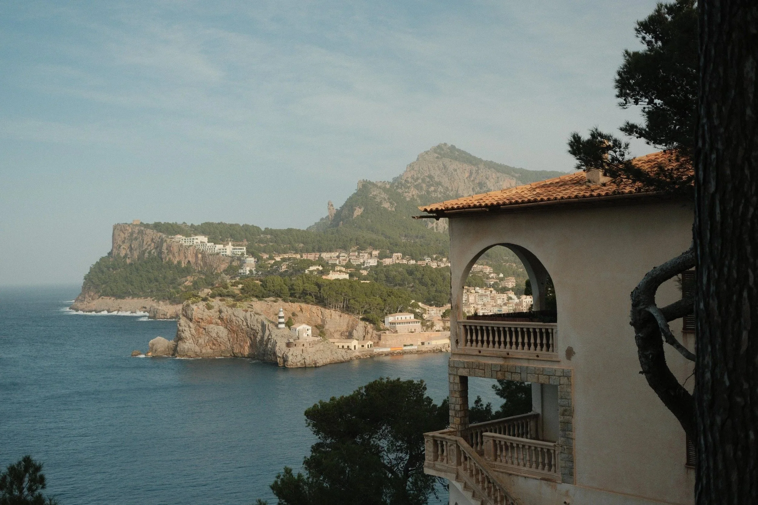 Coastal cliffs seen past a stone watchtower window, Serra de Tramuntana, Mallorca, Spain - fine art print by Zyan Sachs