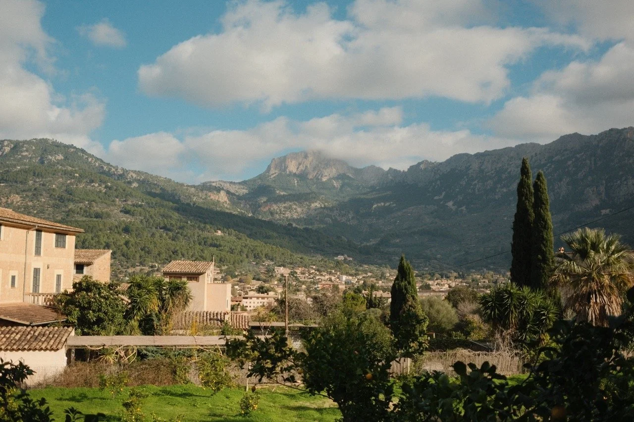 Mountain village and cypresses in a green valley of the Serra de Tramuntana, Mallorca, Spain, by Zyan Sachs