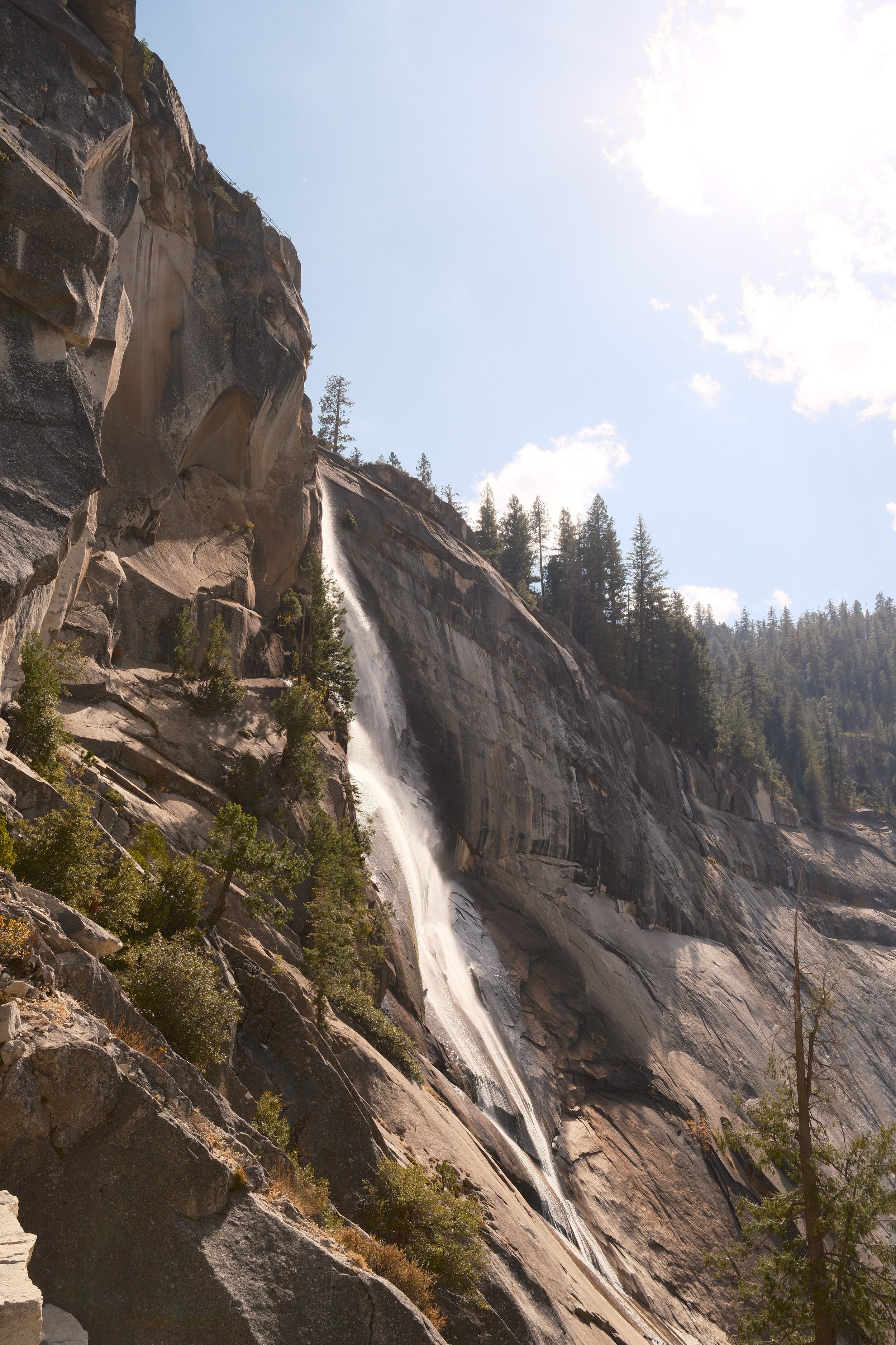 Nevada Fall sliding down a sunlit granite wall along the Mist Trail, Yosemite National Park, California, by Zyan Sachs
