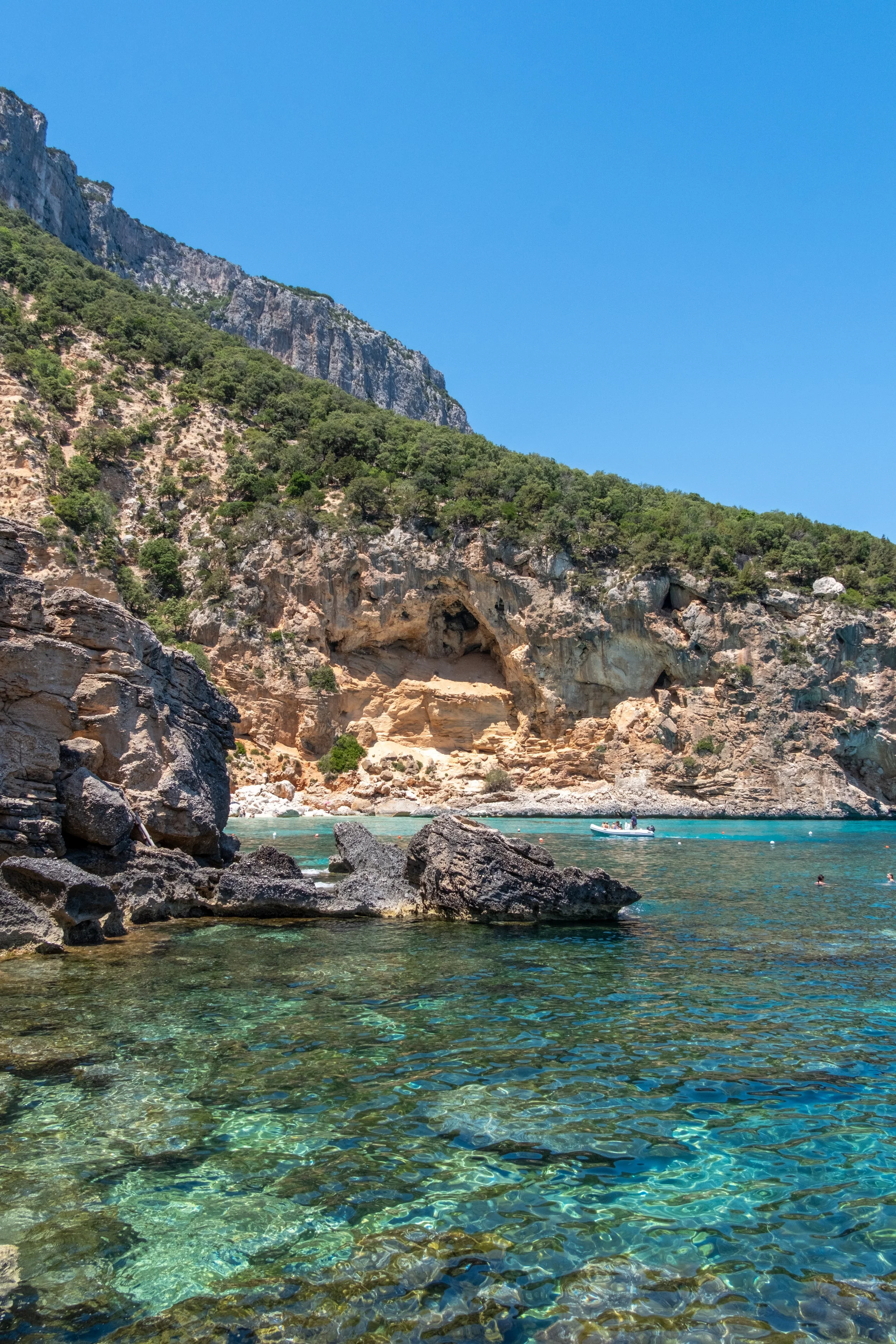 Crystal-clear green water over rocks in a cove, Gulf of Orosei, Sardinia, by Zyan Sachs for Gonone Rental