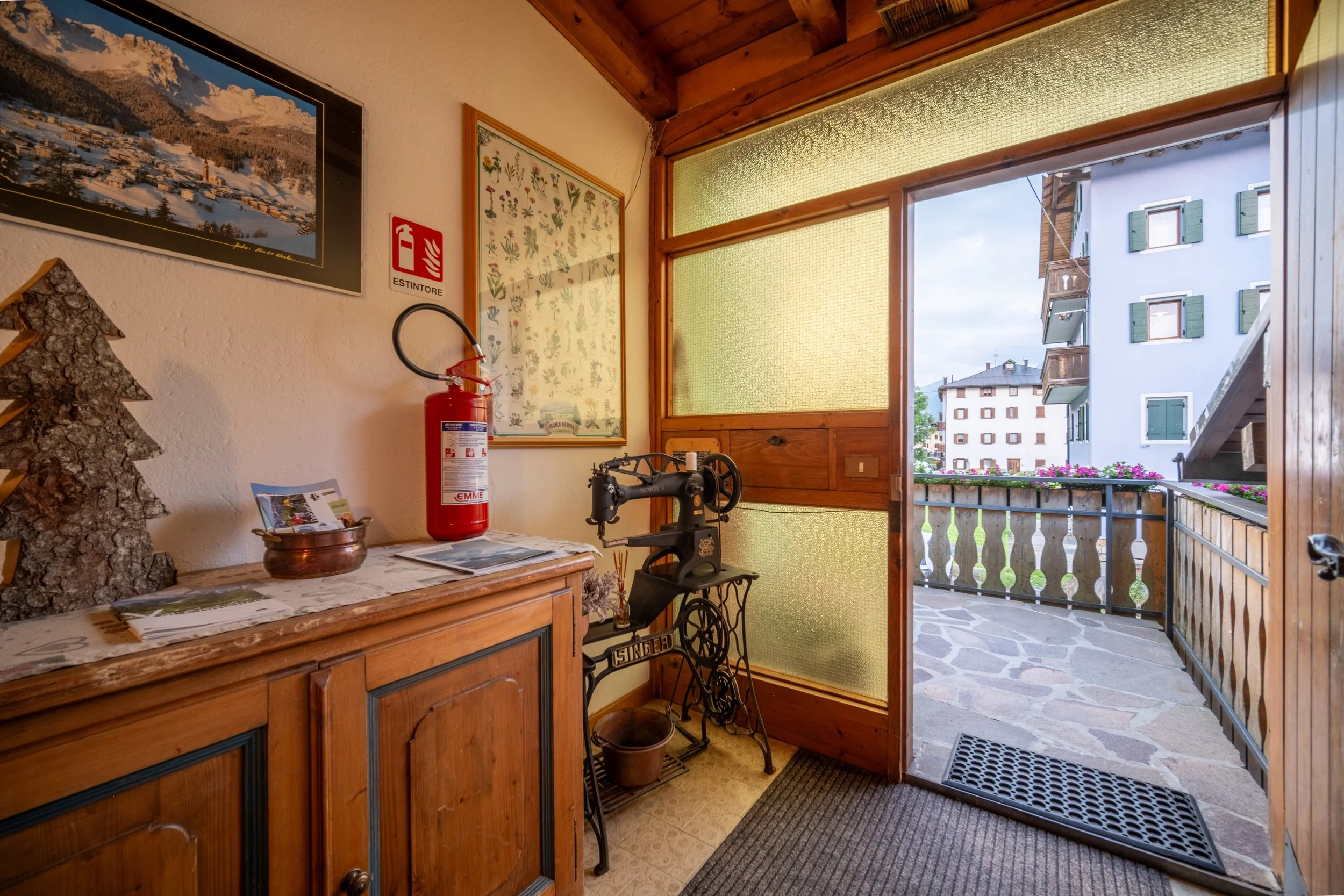 Kitchen opening onto a sunny balcony at Al Borgo da Agata, Dolomites, by Zyan Sachs