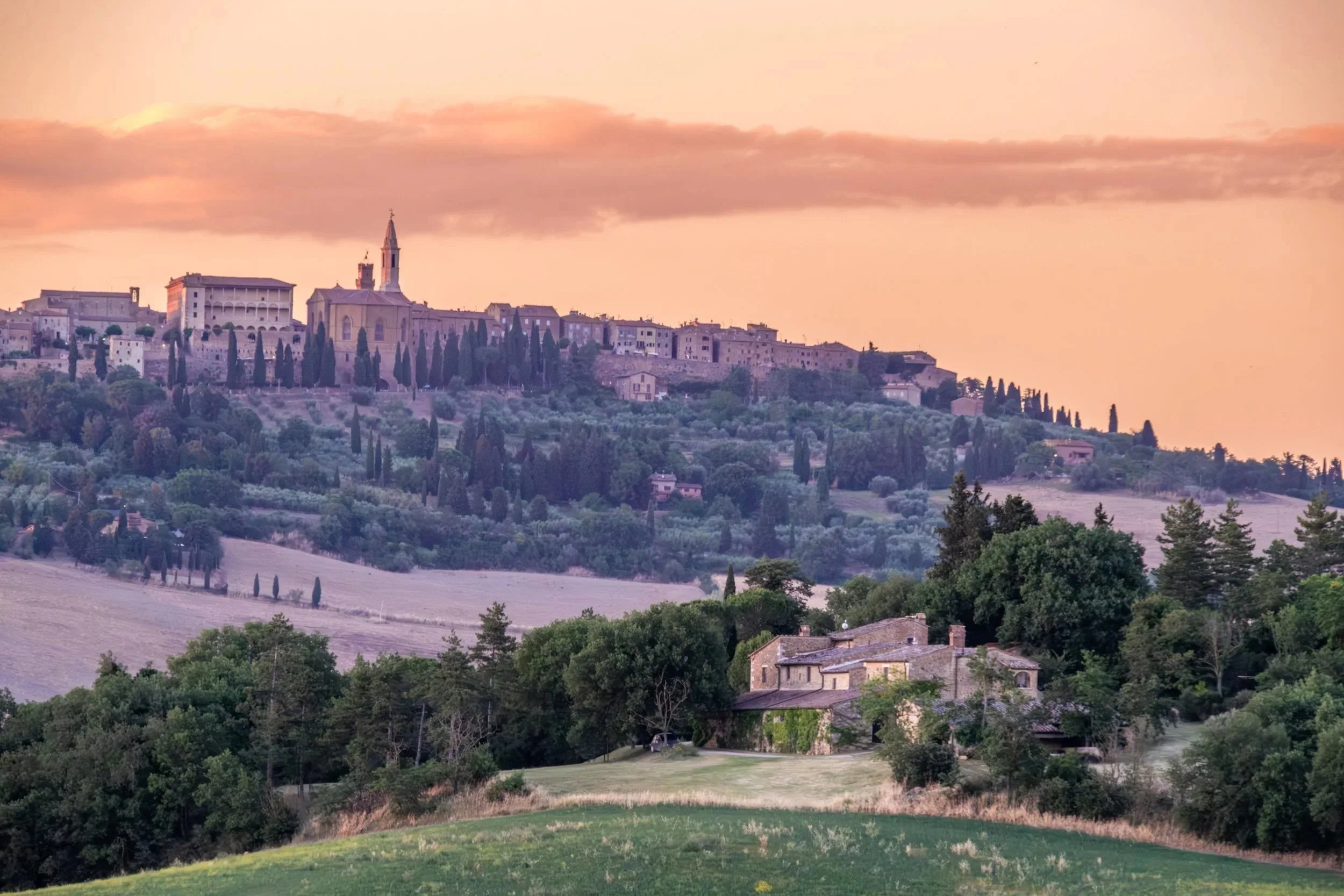 Pienza on its hilltop at sunset, seen from Agriturismo Selvoli, Val d'Orcia, Tuscany - hospitality photography by Zyan Sachs