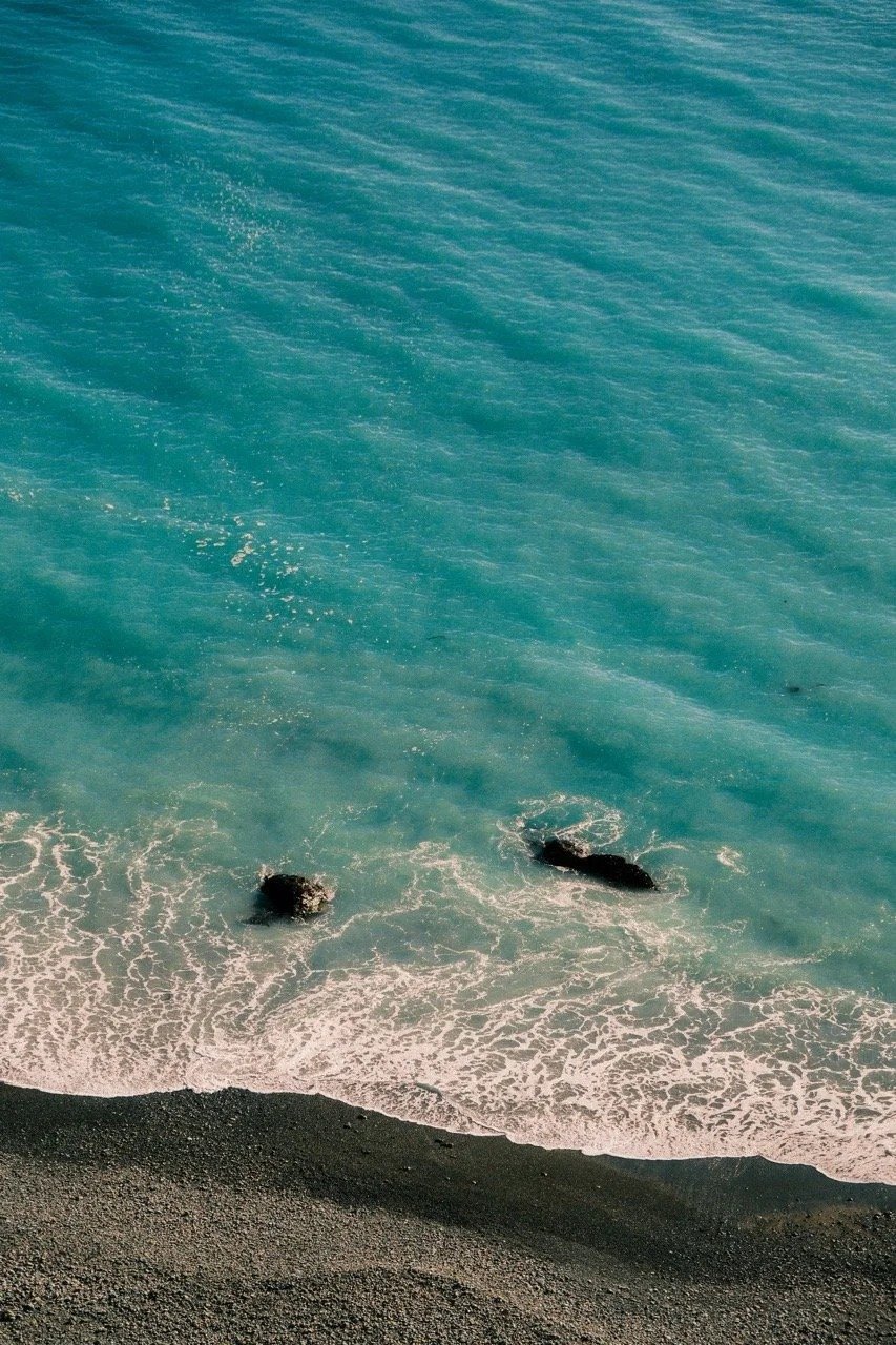 Aerial view of turquoise waves washing onto the sand, California - travel photography and fine art prints by Zyan Sachs