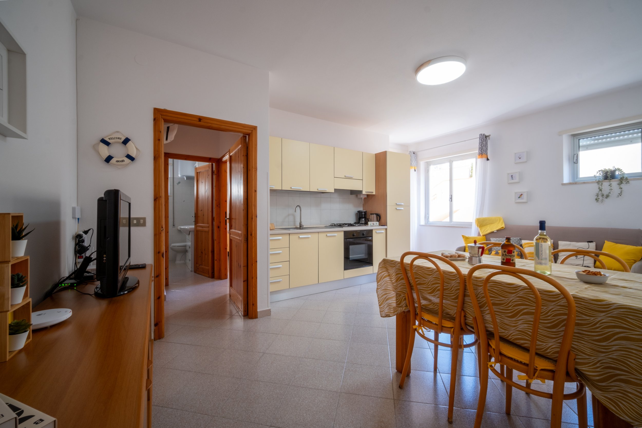 Open-plan living room, dining table and kitchen at Casa Stefano, Sardinia, by Zyan Sachs
