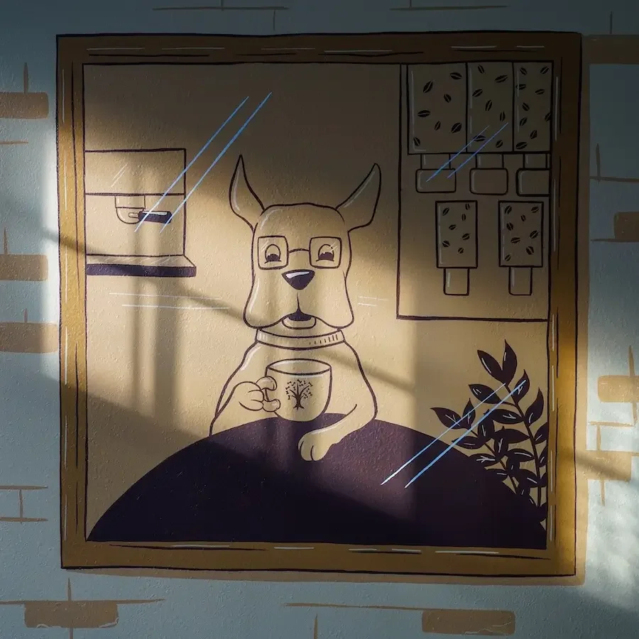 Painted line drawing of dog sitting at a table looking forward