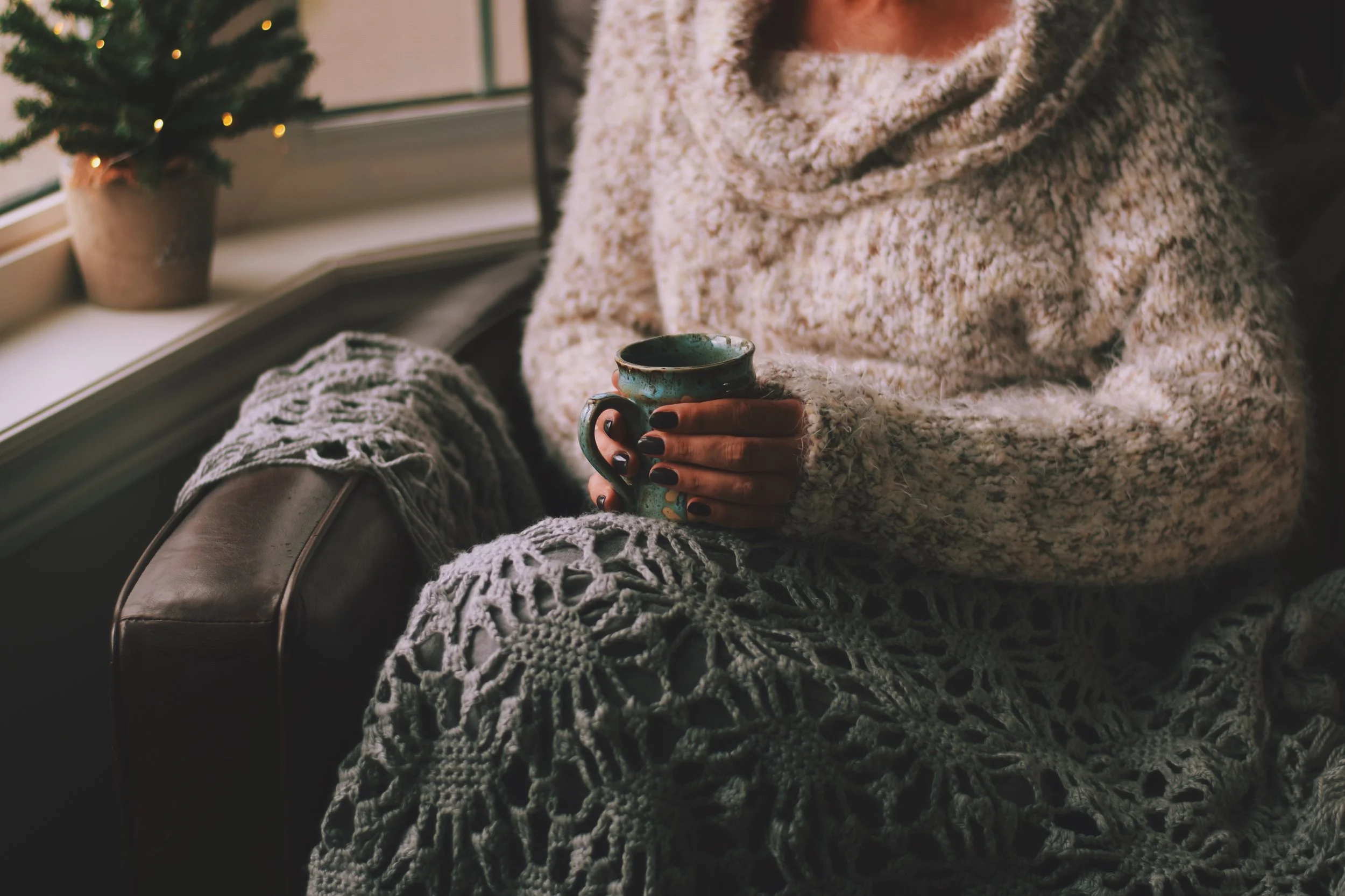 woman-in-a-warm-and-cozy-sweater-sitting-on-a-chai-2026-01-09-00-54-55-utc.jpg