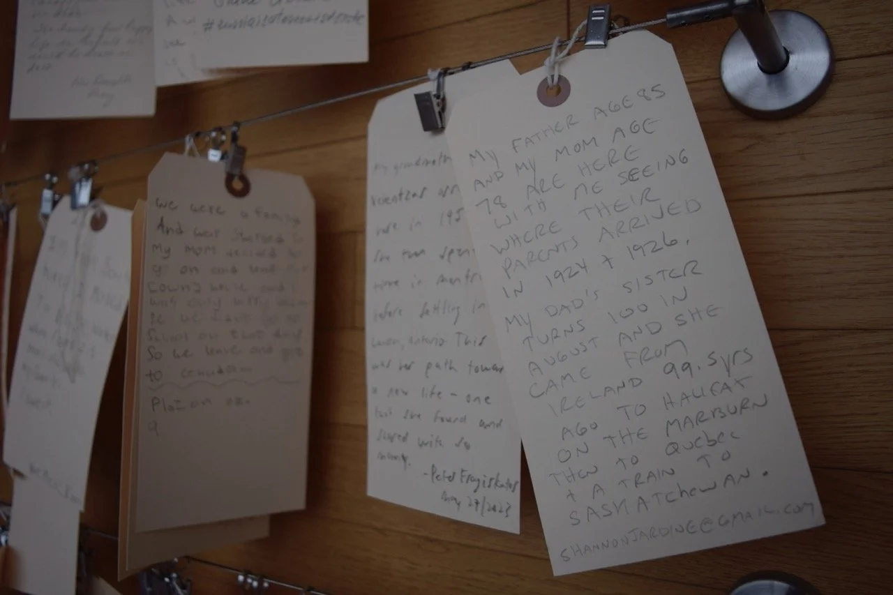 Close up of paper tags with handwritten notes on them.