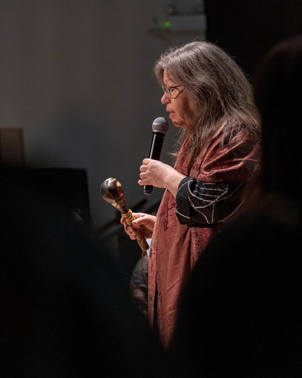 Close up of a person with a microphone in hand.