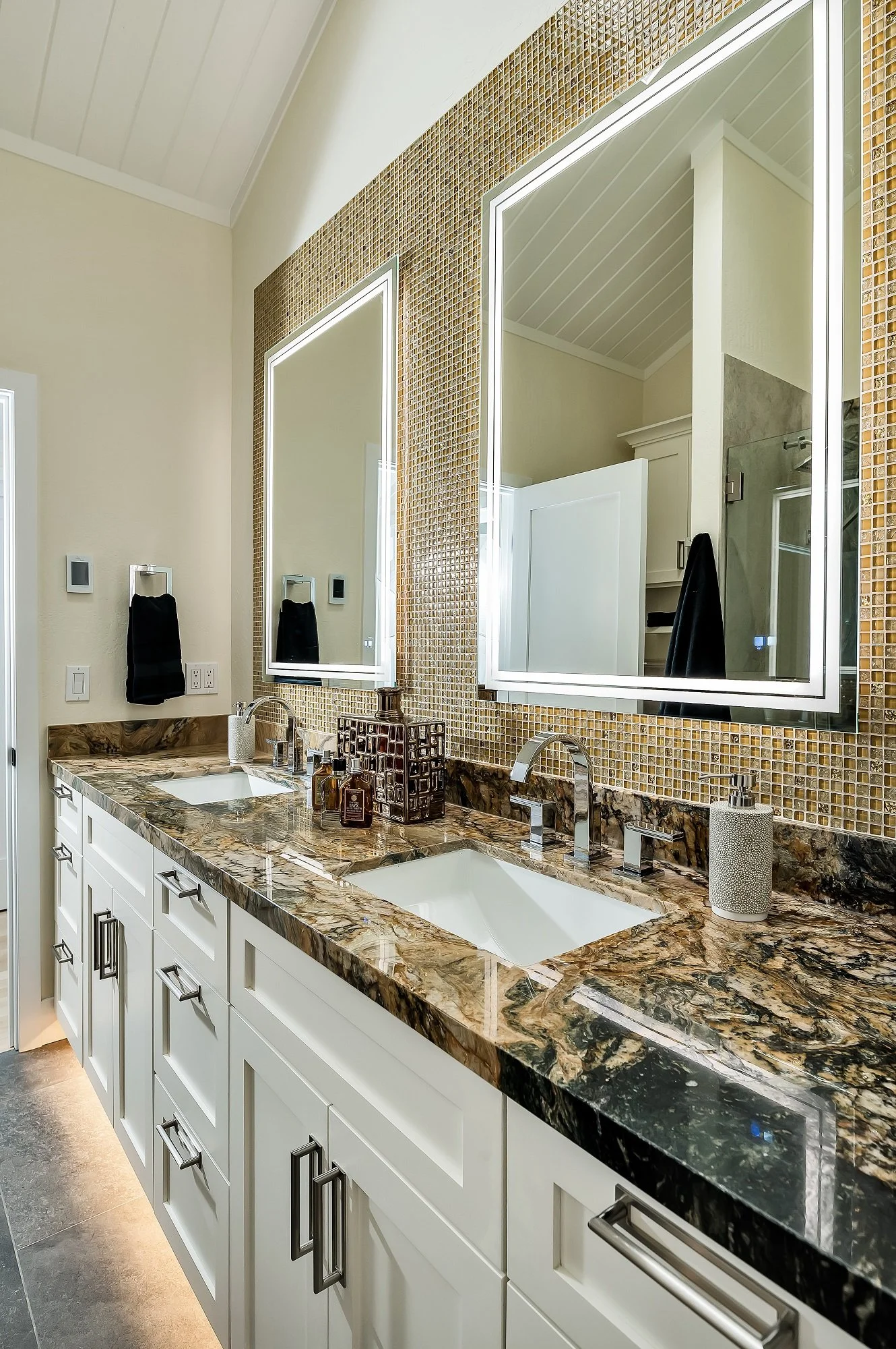 Double vanity remodel with dramatic marble countertop, mosaic tile backsplash, and LED lighted mirrors — Santa Cruz