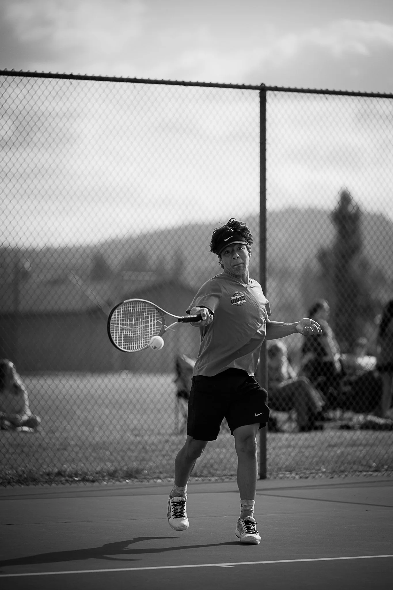 Young man swinging tennis racquet and breaking strings on hit