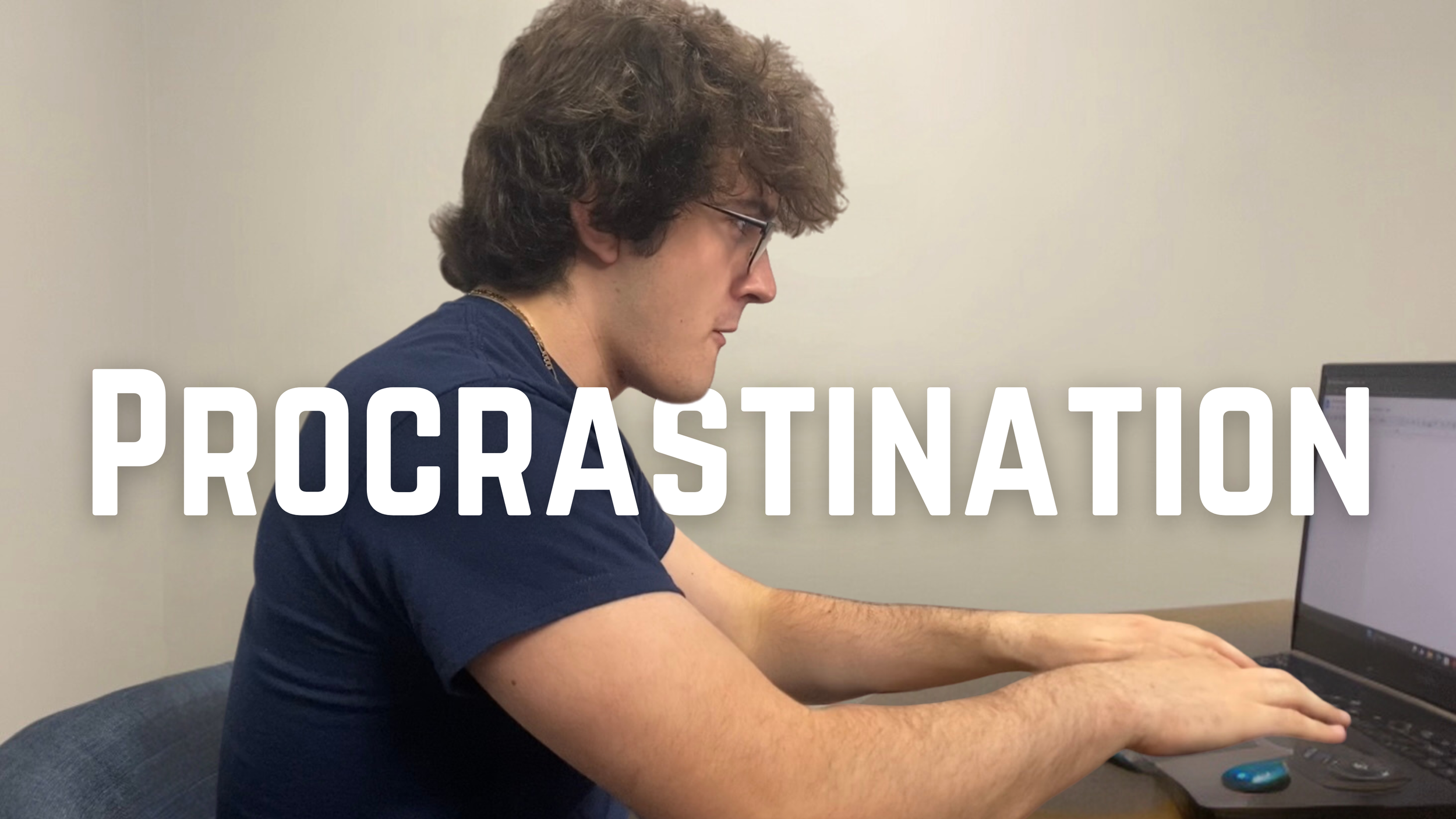 A young man with curly brown hair and glasses sitting at a desk, looking at a laptop. The word 'PROCRASTINATION' is overlaid across the image.