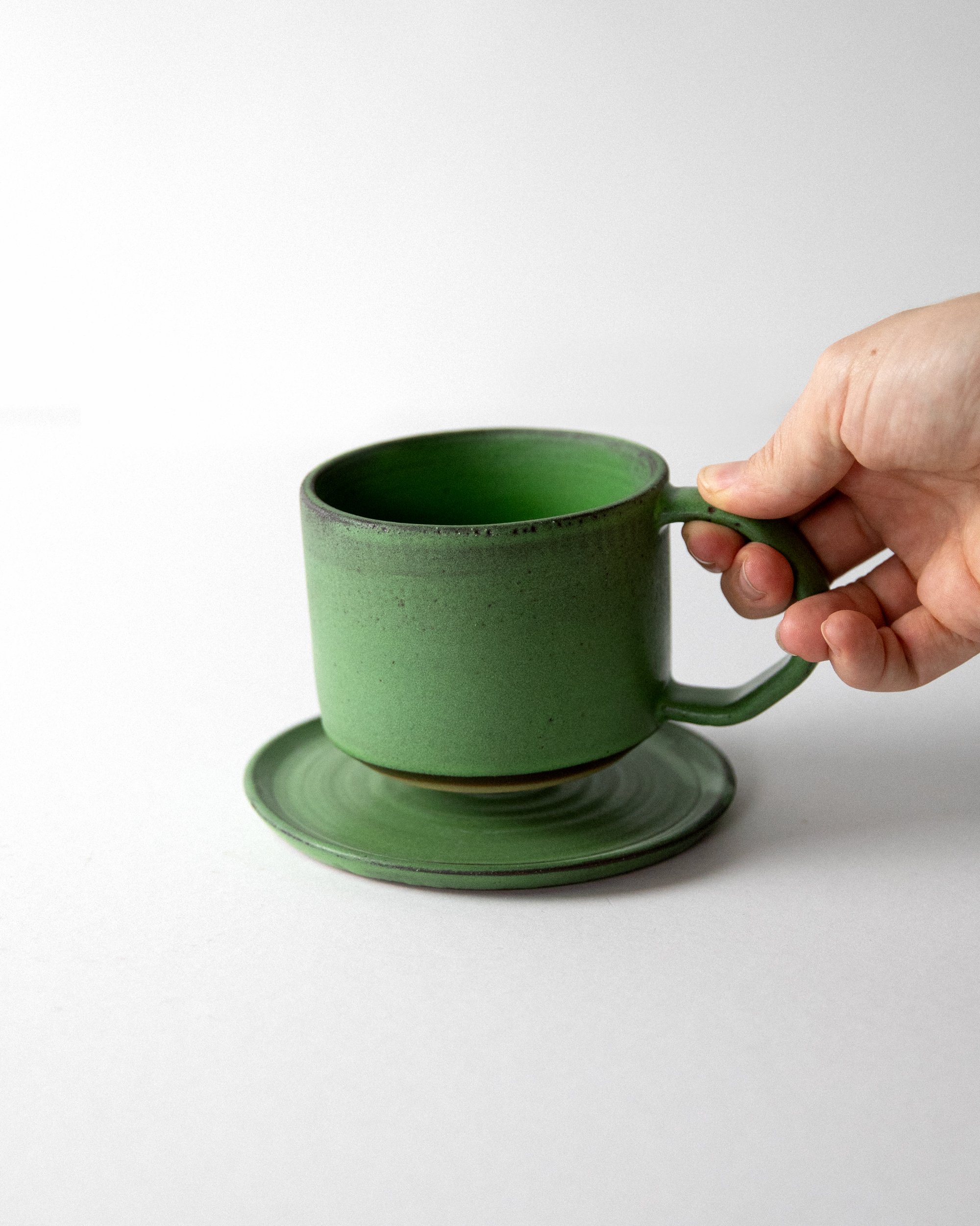Coffee-Cup-Green-with-saucer-holding.jpg