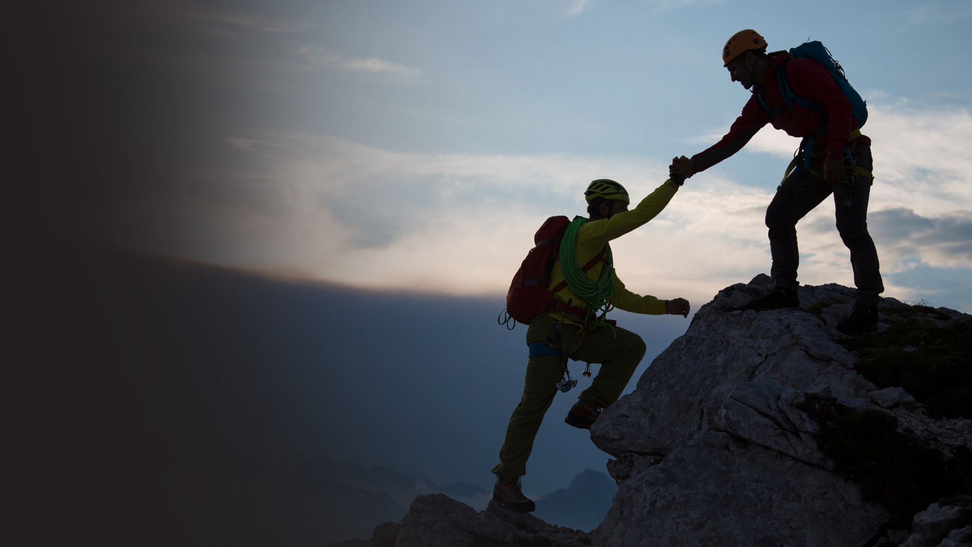 Hiker reaching out a helping hand to another hiker