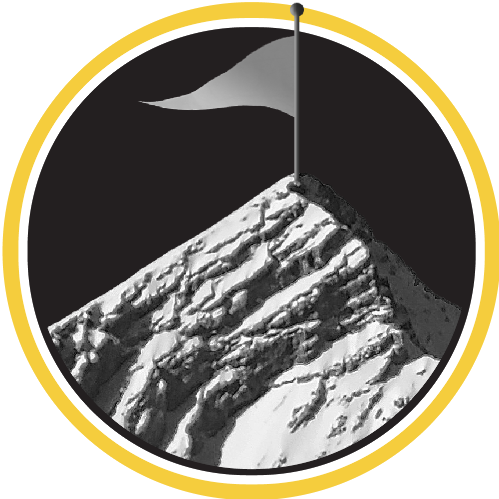 A flag planted high atop a mountain peak