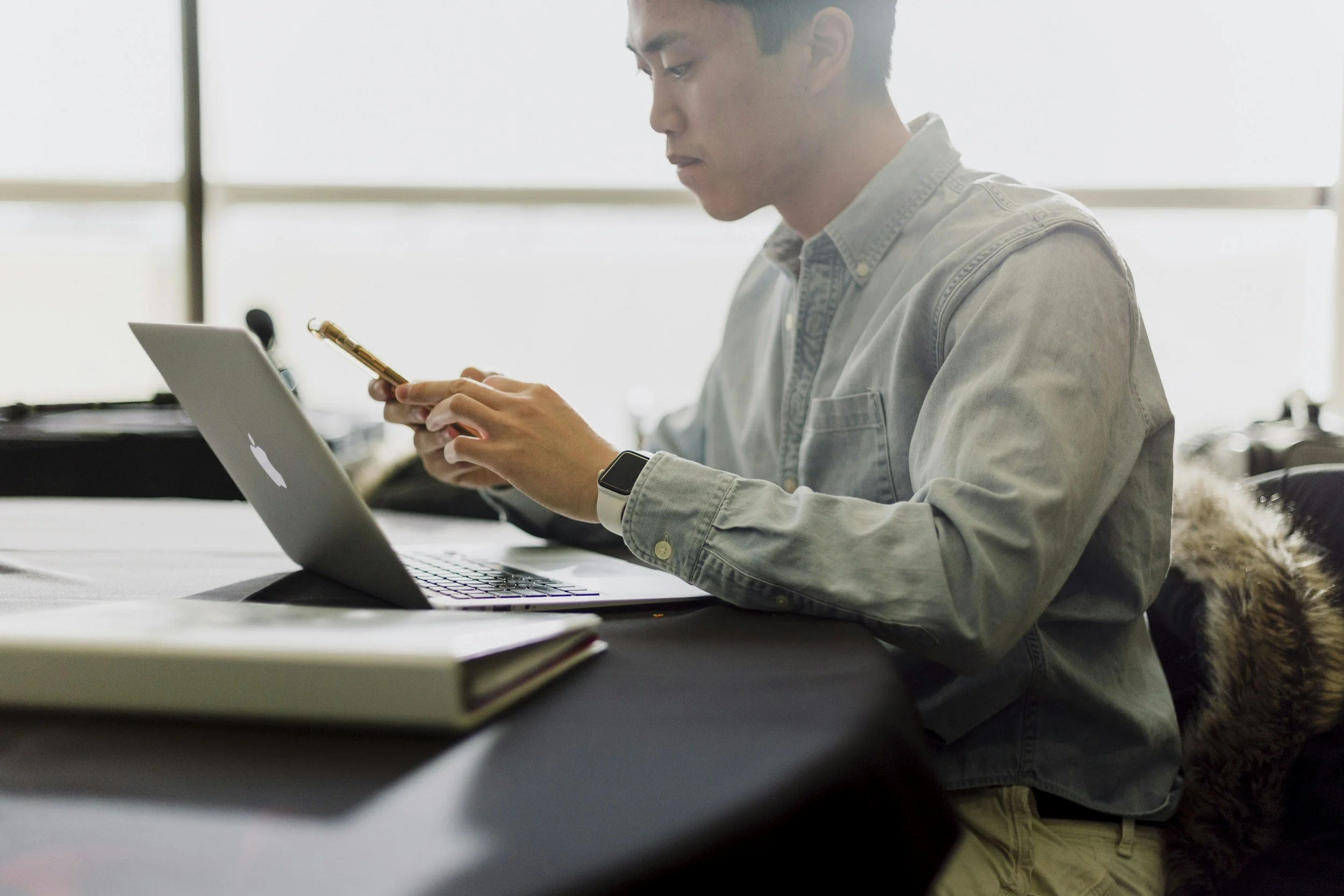 Man at a computer on his phone