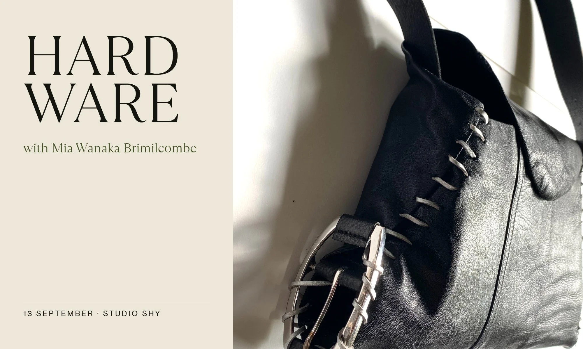 Close-up of a black leather bag with a pale whipstitched edge and a metal buckle fastening, beside a card reading HARDWARE with Mia Wanaka Brimilcombe, 13 September, Studio SHY.
