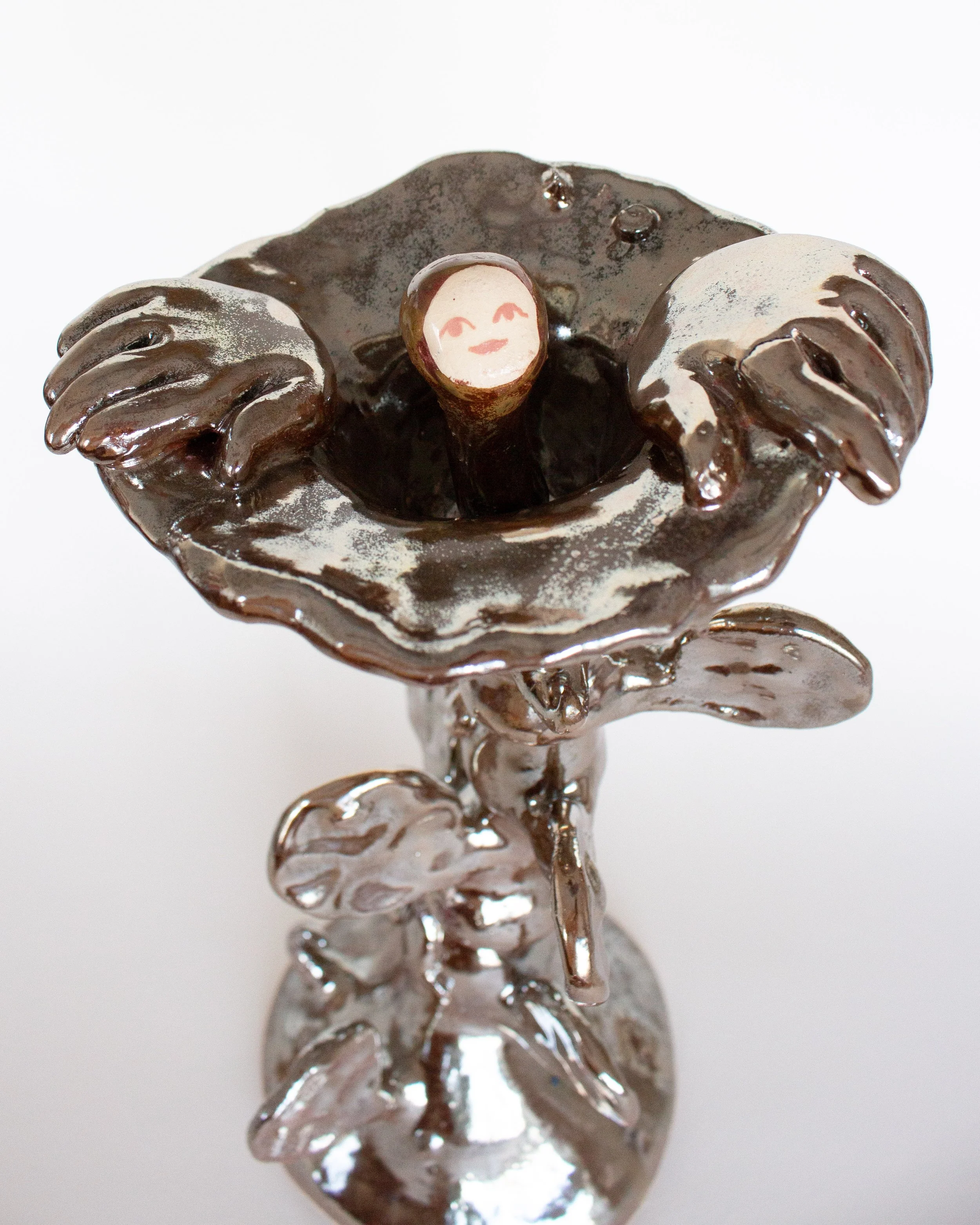 A metallic-looking ceramic flower with a creature inside by German artist Malwine Stauss.