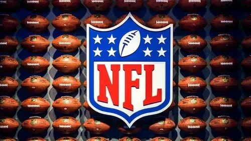 A large NFL logo centered over a wall of footballs for Windy City Sports Cards football inventory.