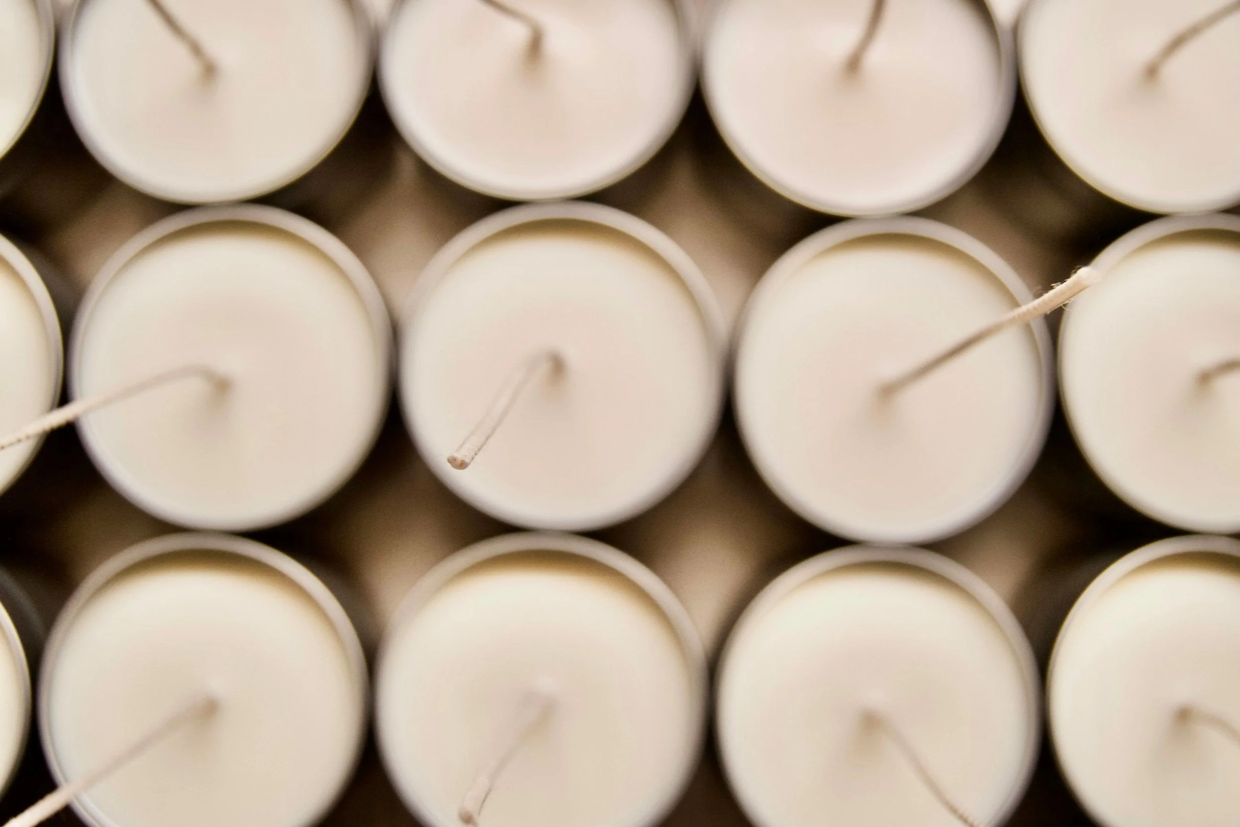 Image of hand-poured candles in tins.