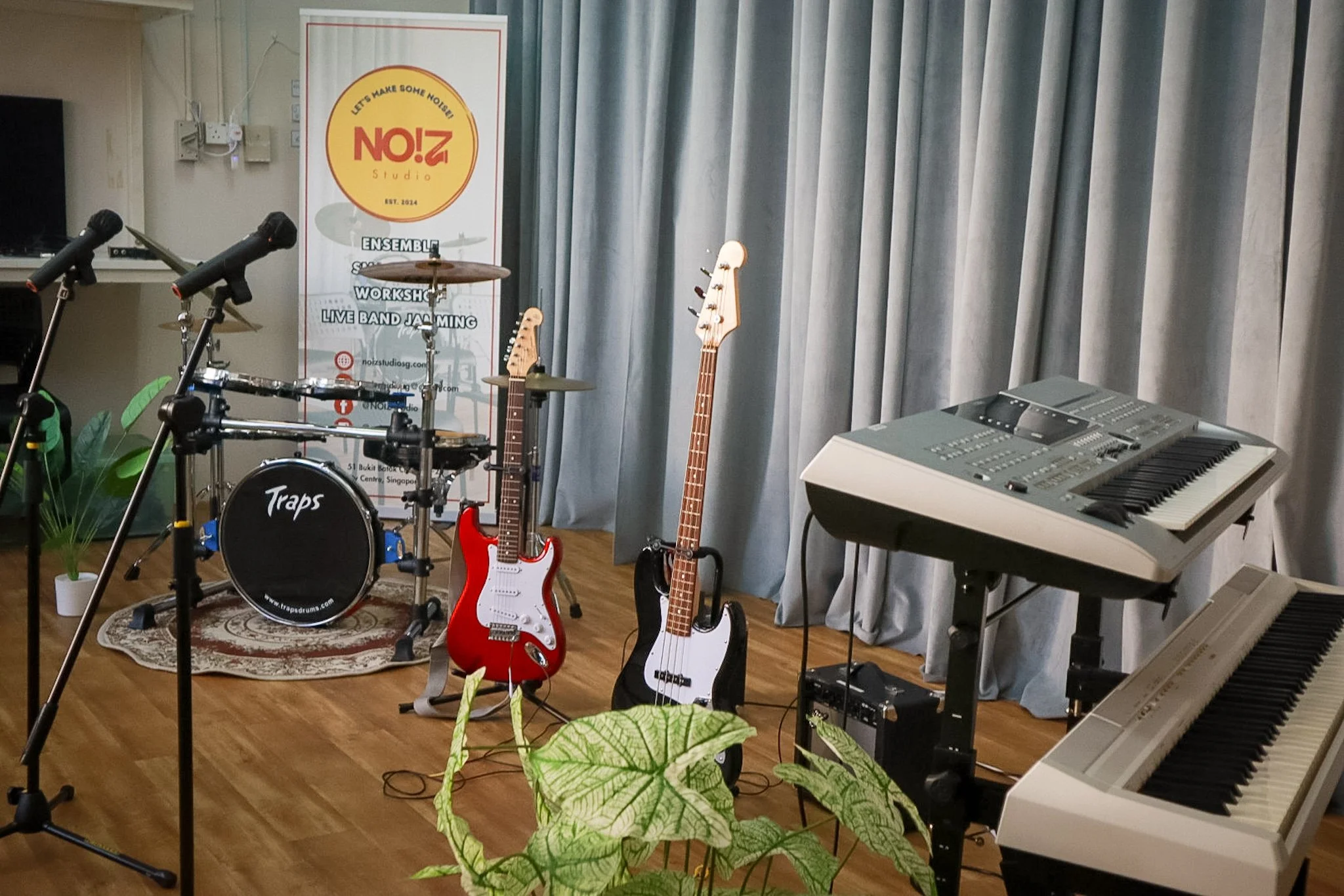 live band jamming with drumset, electric guitar, bass guitar, keyboard, digital piano and 2 wireless microphones