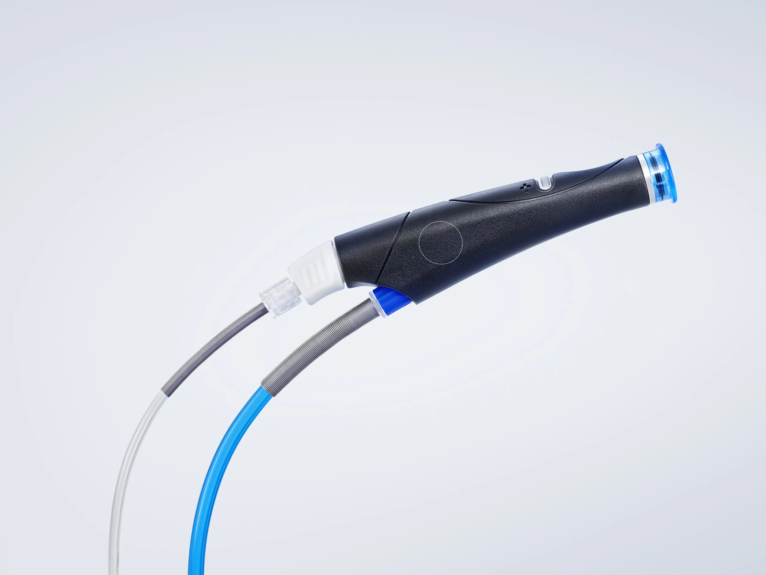 A medical instrument with a black handle and blue accents connected to two tubes, one clear and one blue, set against a light background.