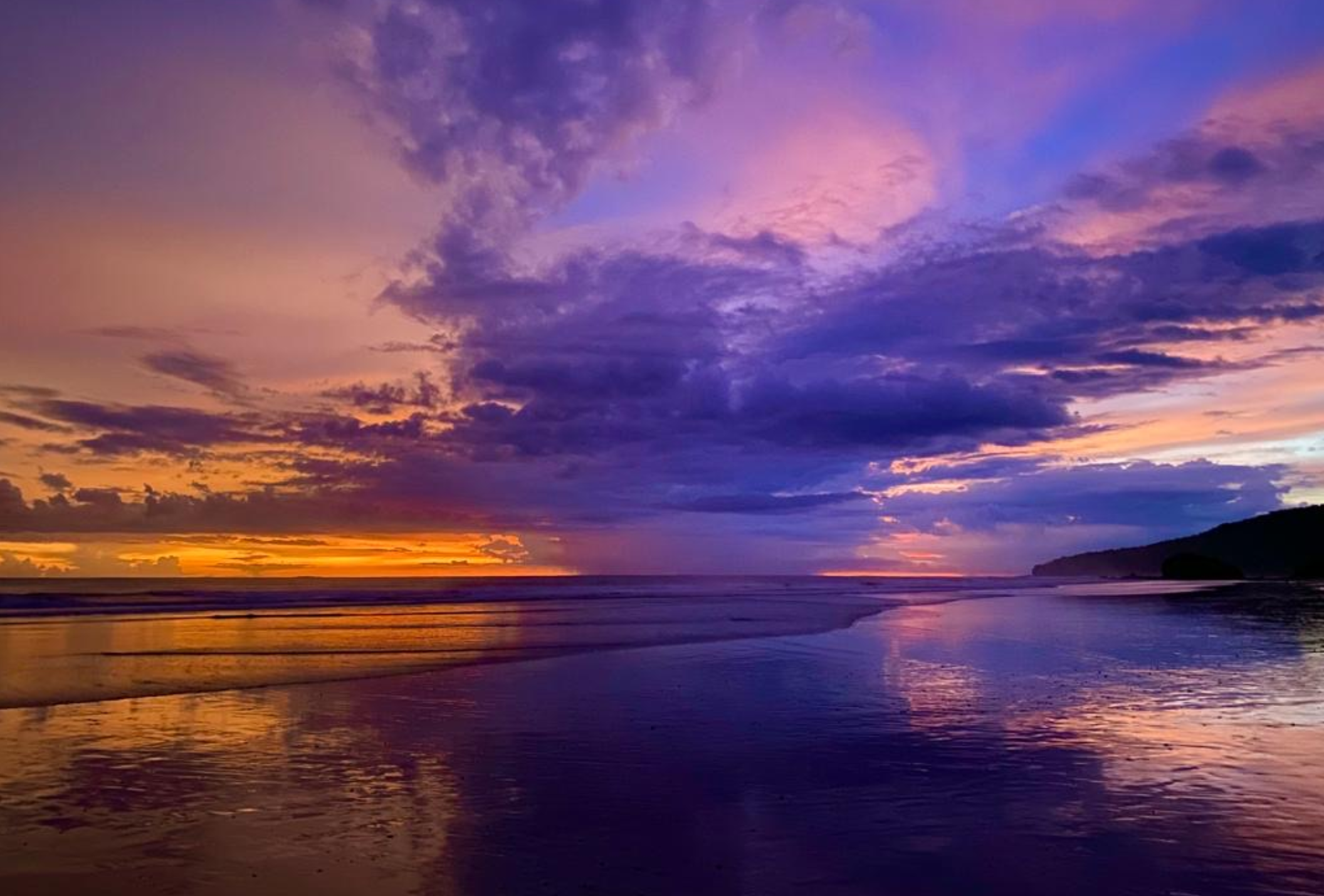 A vibrant sunset over a calm beach in Playa Grande Costa Rica while earning Continuing Education credits on vacation.