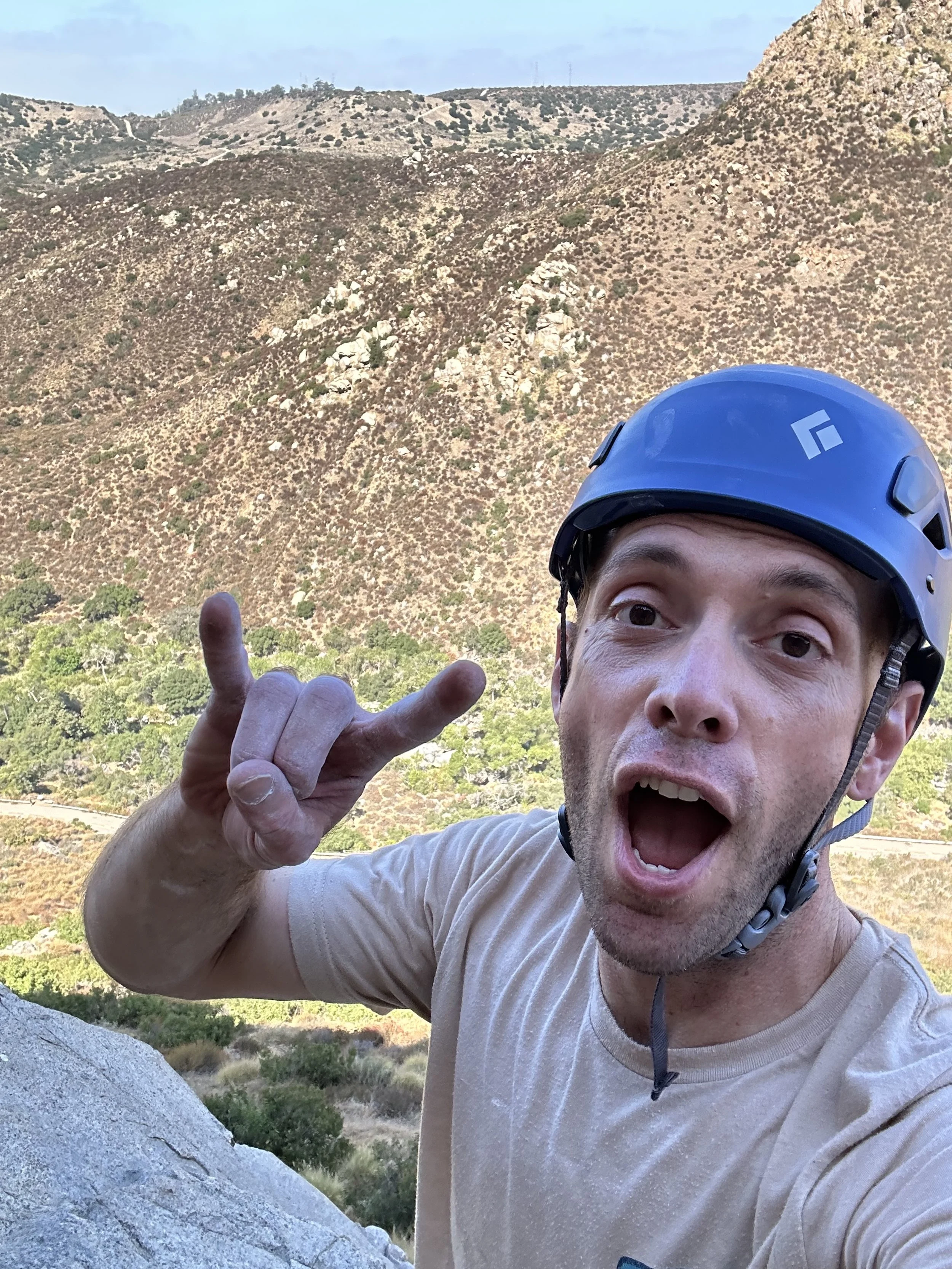 Rock climber wearing a black diamond Half Dome helmet taking a selfie in Mission Trails Regional Park, San Diego, CA